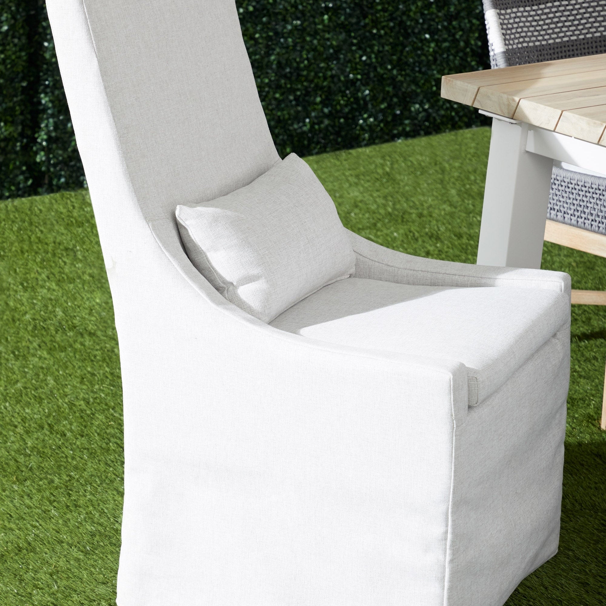 Adele Outdoor Slipcover Dining Chair with removable cushion and lumbar pillow on green grass by Essentials for Living