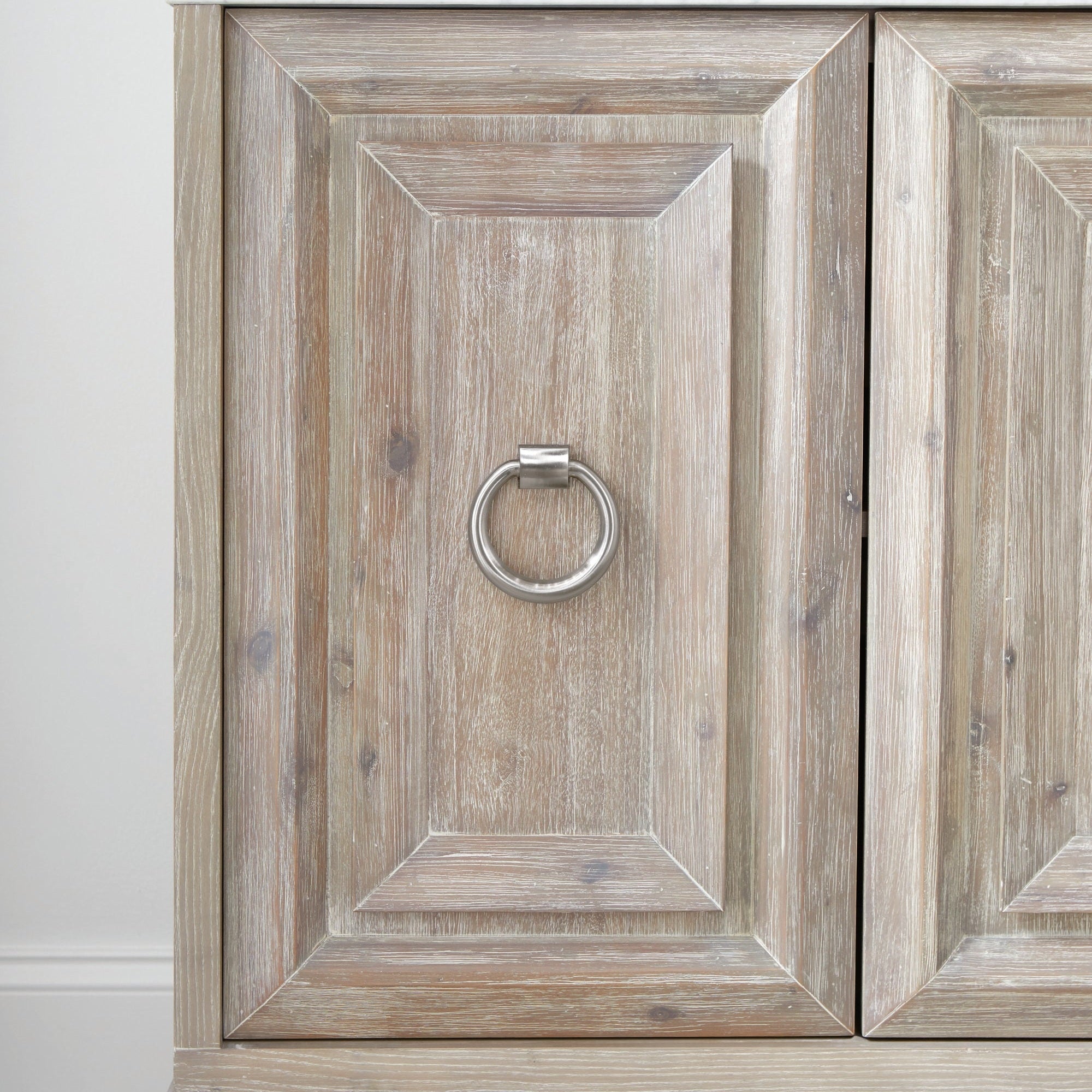 Close-up of textured wood cabinet door with brushed gold ring pull on Azure Carrera Media Sideboard by Essentials For Living
