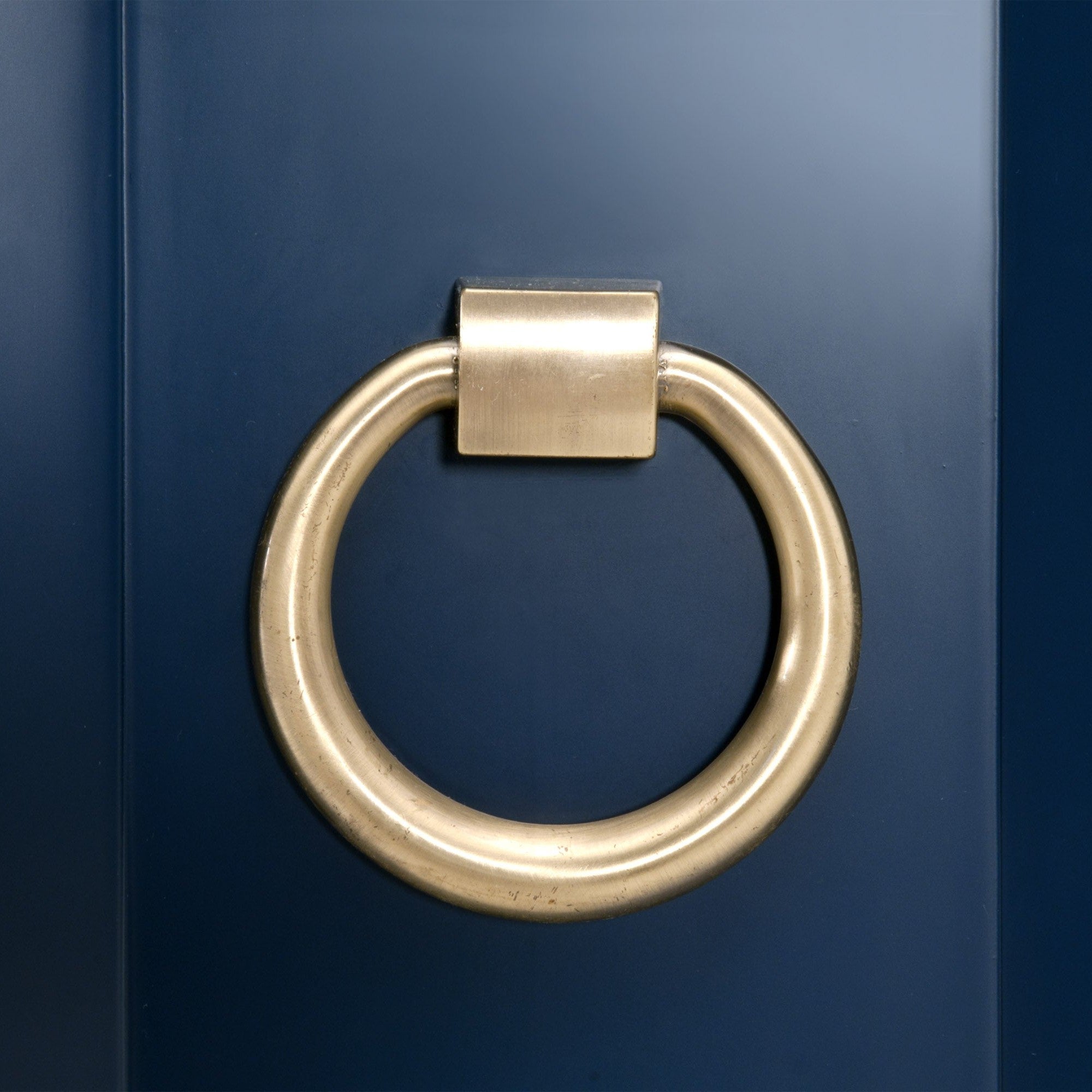 Brushed gold oversized ring pull on navy lacquered Azure Carrera Media Sideboard by Essentials for Living