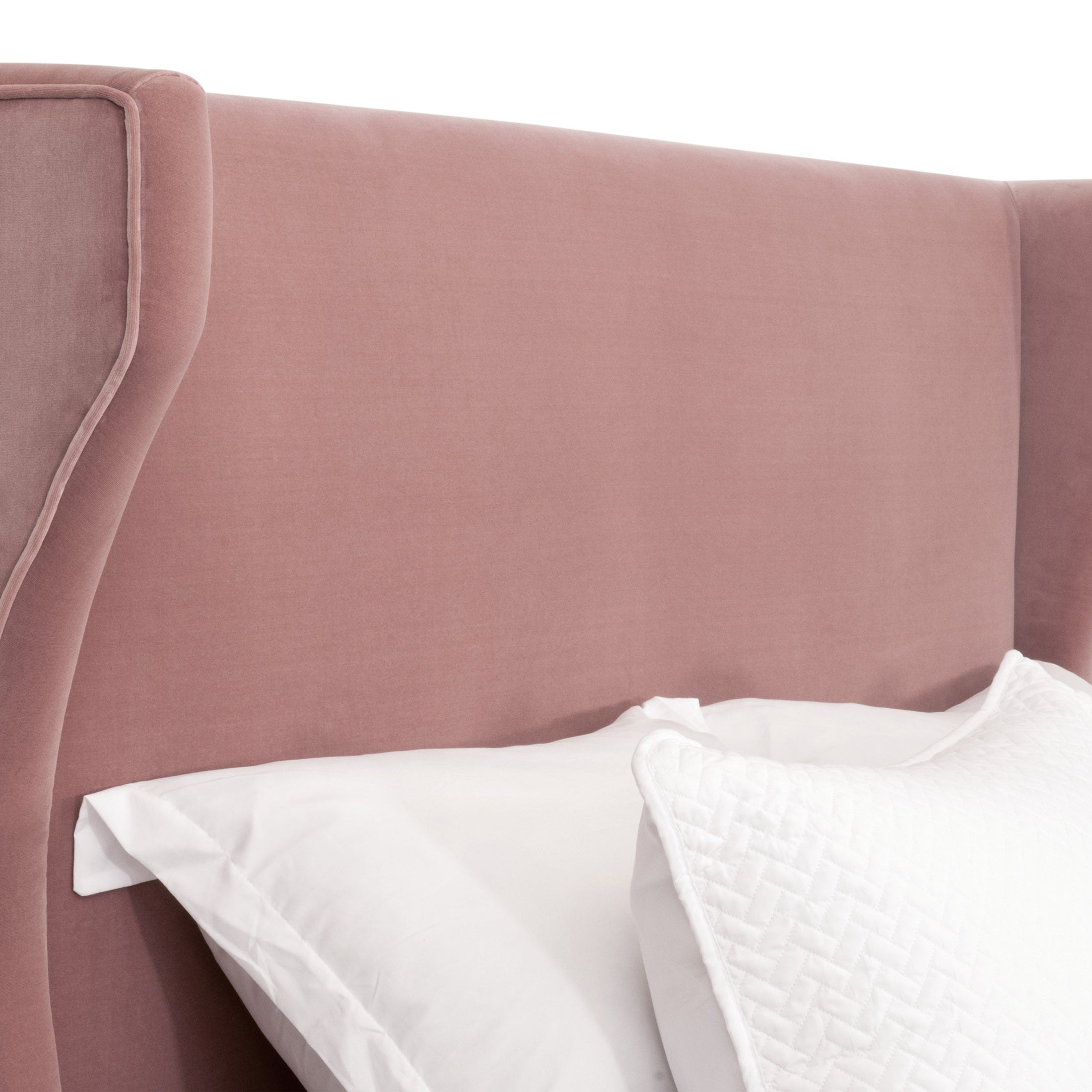 Close-up of Balboa Queen Bed with curved wingback headboard and piped edges by Essentials for Living