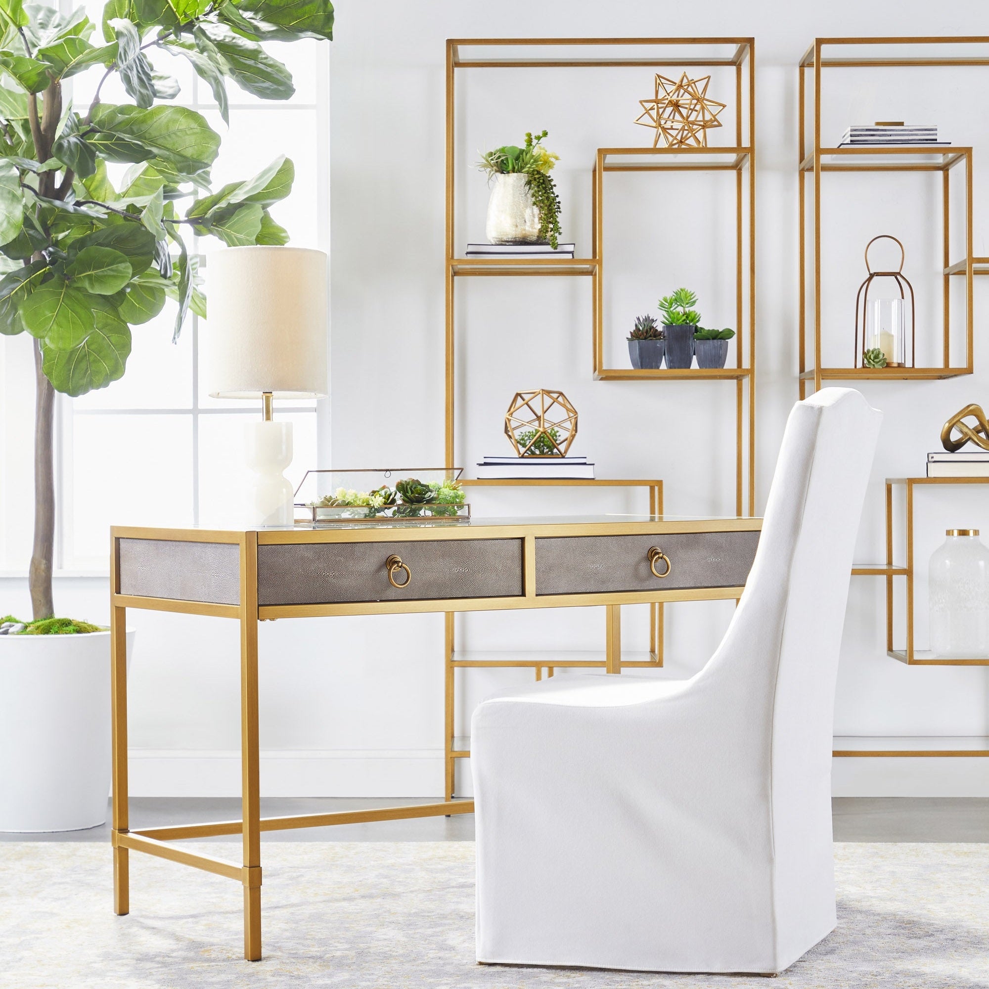 Beakman Bookcase with brass metal frame and clear glass shelves in modern living room by Essentials for Living