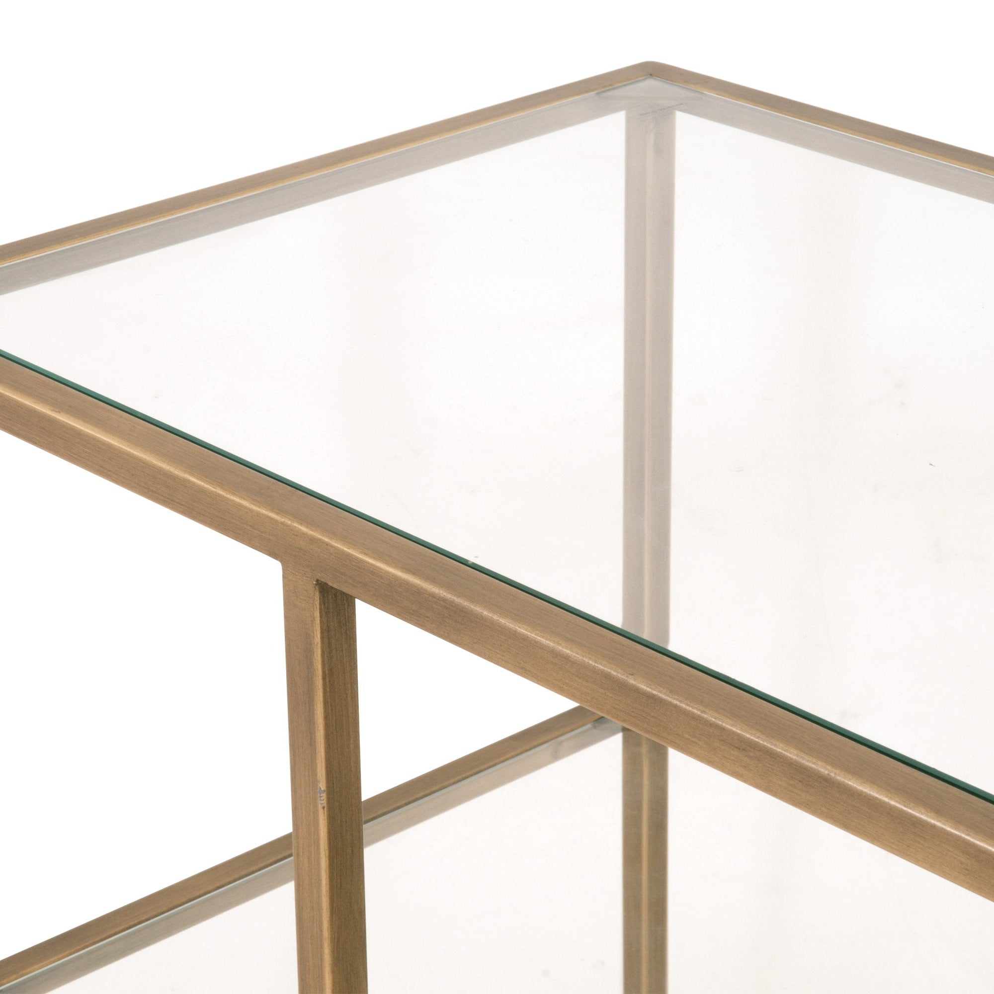 Close-up of Beakman Low Bookcase brass metal frame and clear tempered glass shelves by Essentials for Living