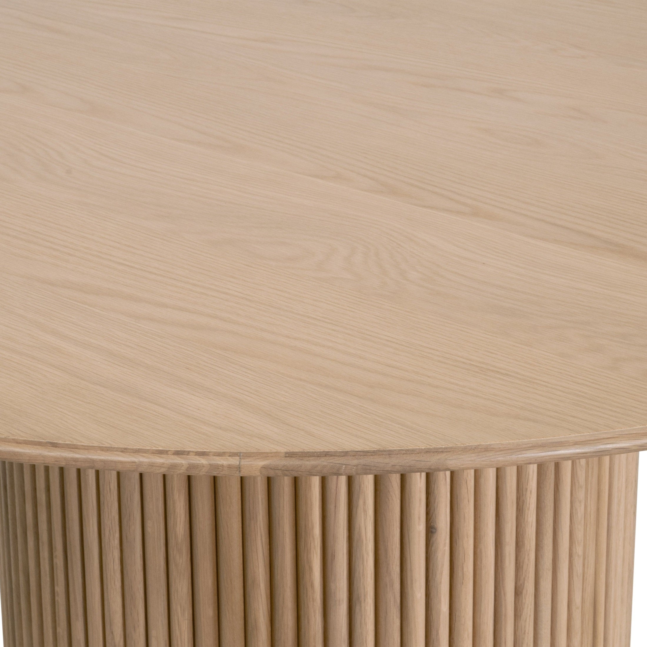 Close-up of Belfast 54" Round Dining Table in natural oak with fluted pedestal base by Essentials for Living.