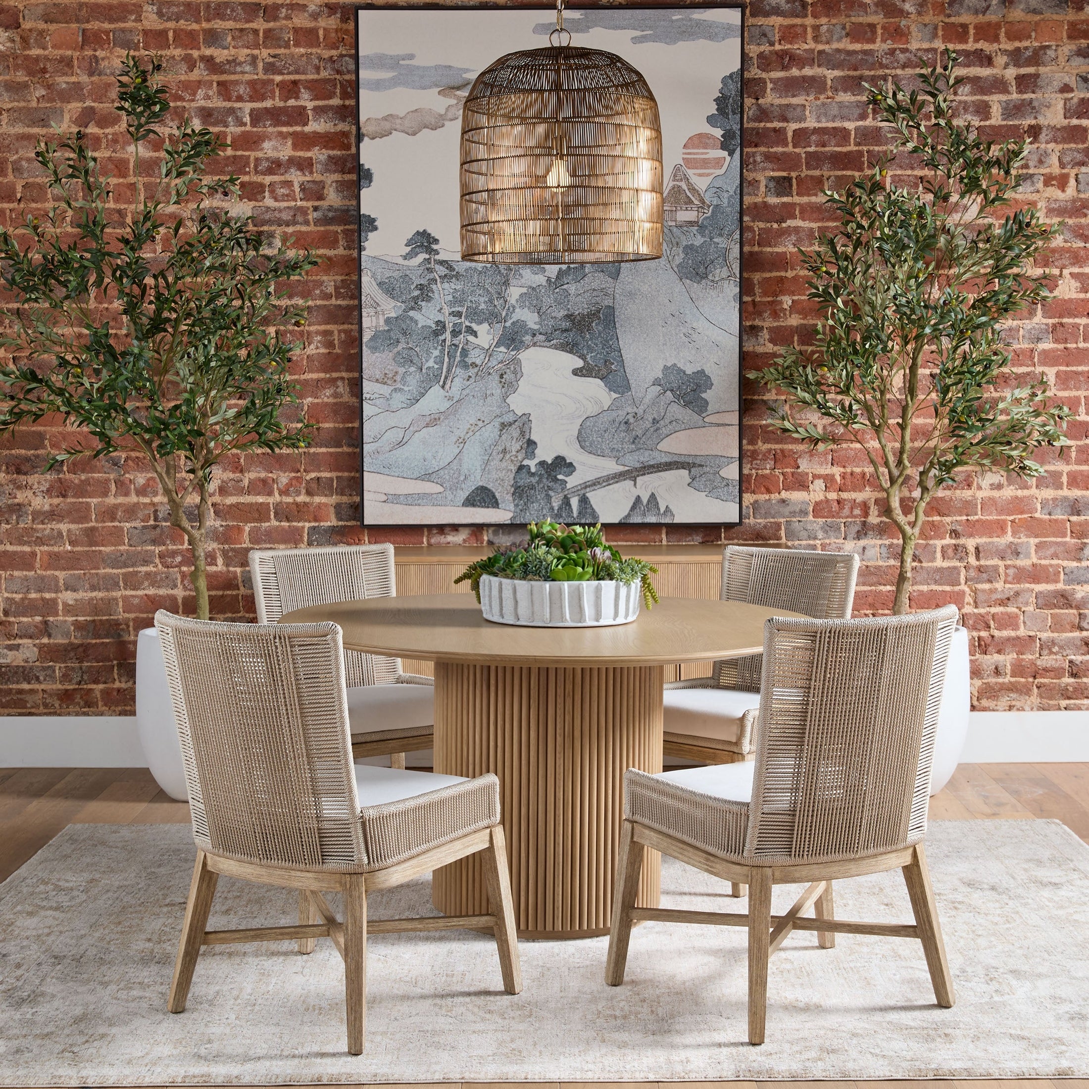 Belfast 54" Round Dining Table in natural oak with fluted pedestal surrounded by four wicker chairs Essentials for Living