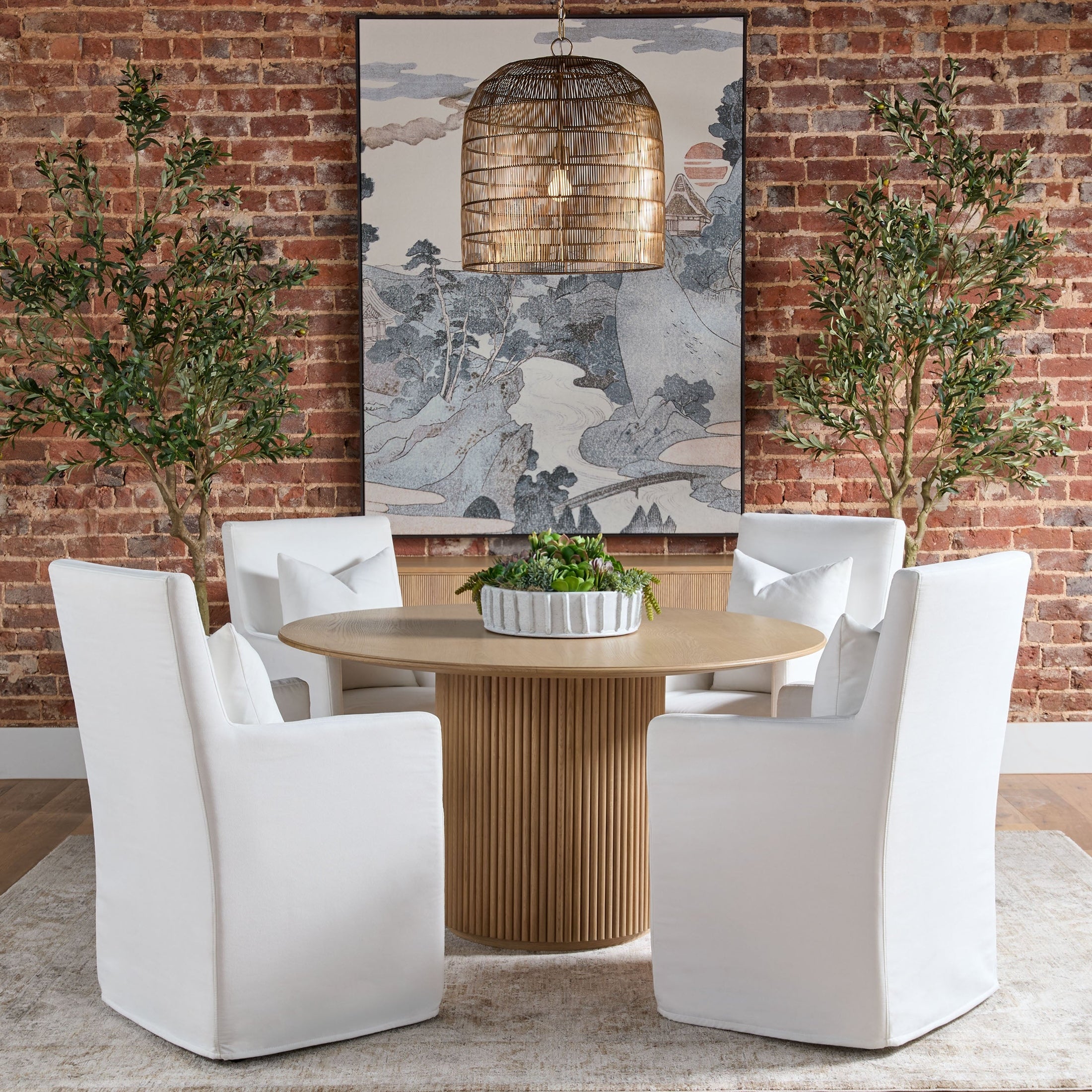 Belfast 54" Round Dining Table with fluted pedestal in natural oak, styled with white chairs Essentials for Living