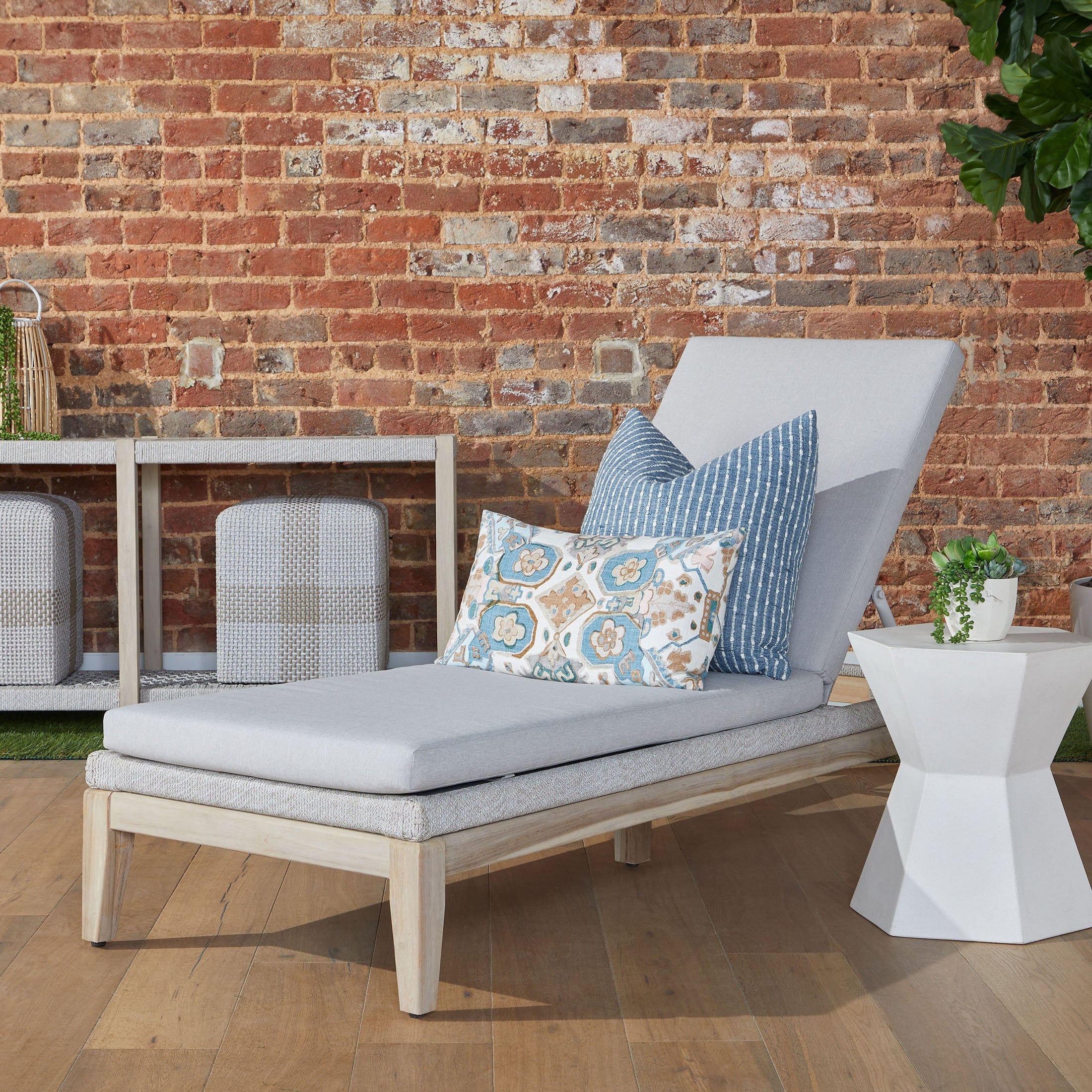 Bento Accent Table in slate gray concrete with hourglass shape beside lounge chair by Essentials for Living