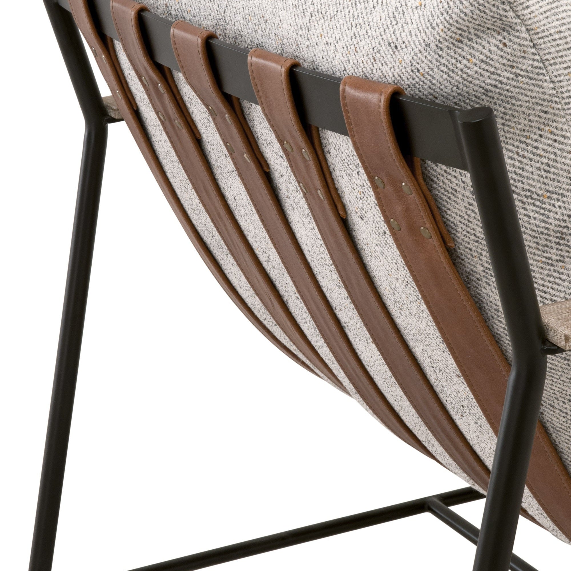 Close-up of chestnut brown leather straps and black iron frame on Brando Club Chair by Essentials For Living