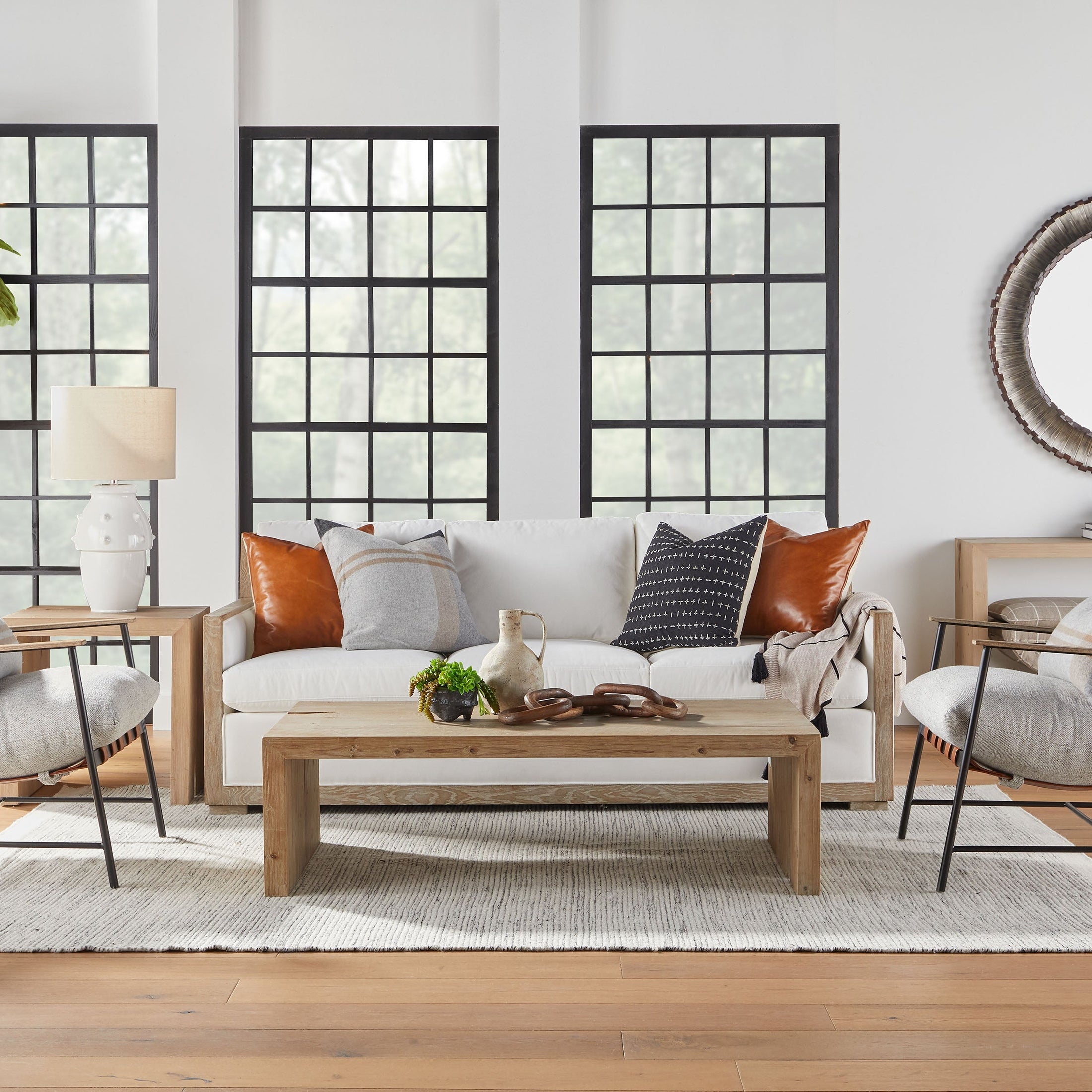 Modern sling-style Brando Club Chair with black iron frame and chestnut leather straps by Essentials for Living