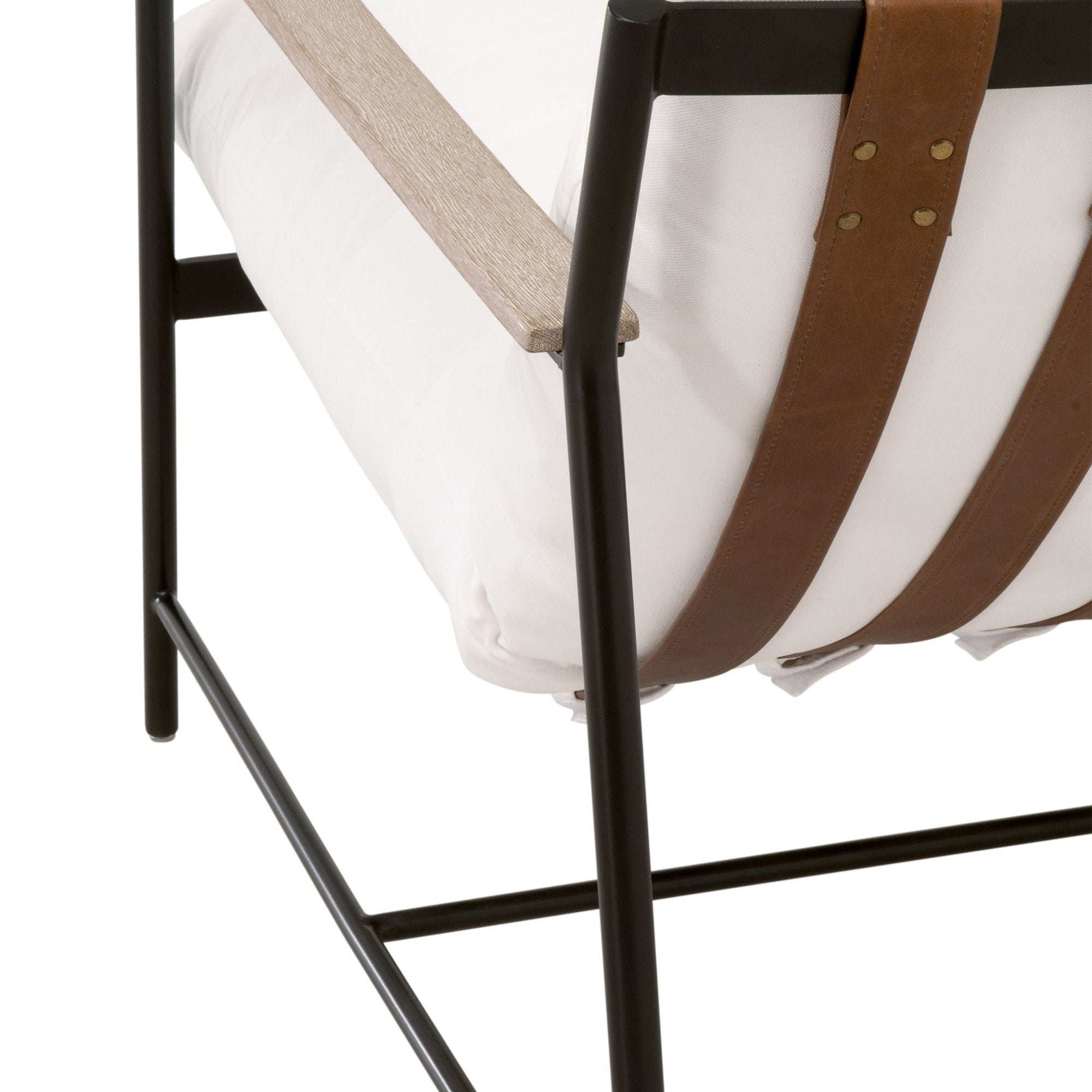 Close-up of Brando Club Chair with black iron frame, natural gray oak armrests, and chestnut leather straps by Essentials for Living.