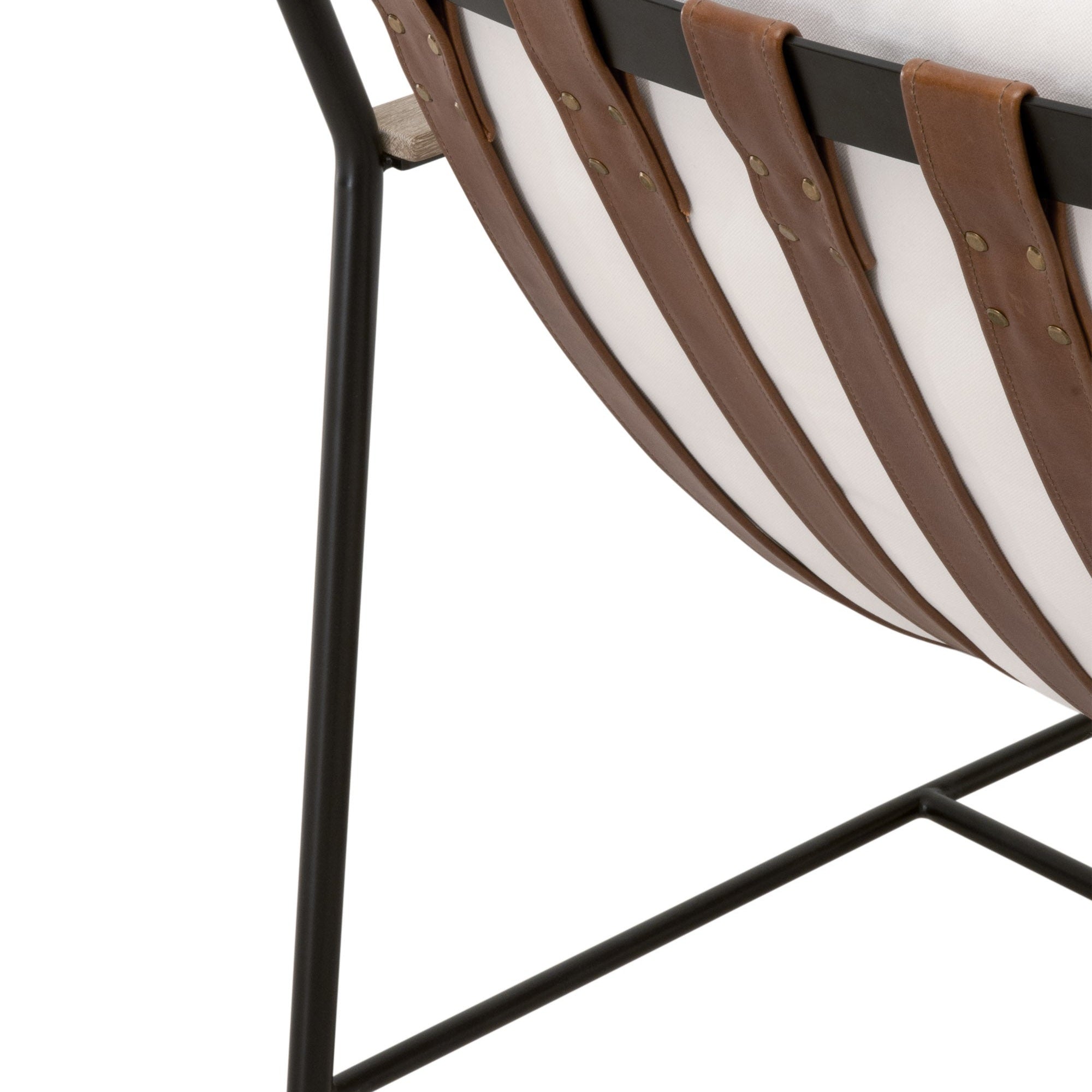 Close-up of Brando Club Chair’s black iron frame and chestnut brown leather straps by Essentials For Living.