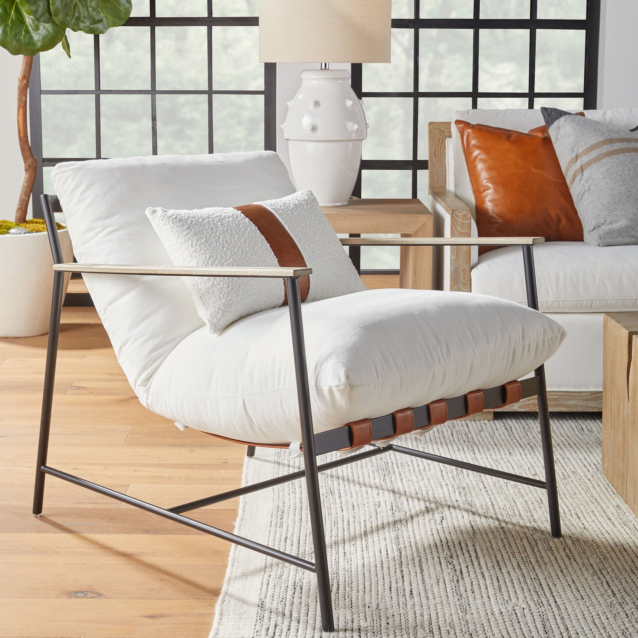 Brando Club Chair with black iron frame and chestnut leather straps in modern room setting by Essentials for Living