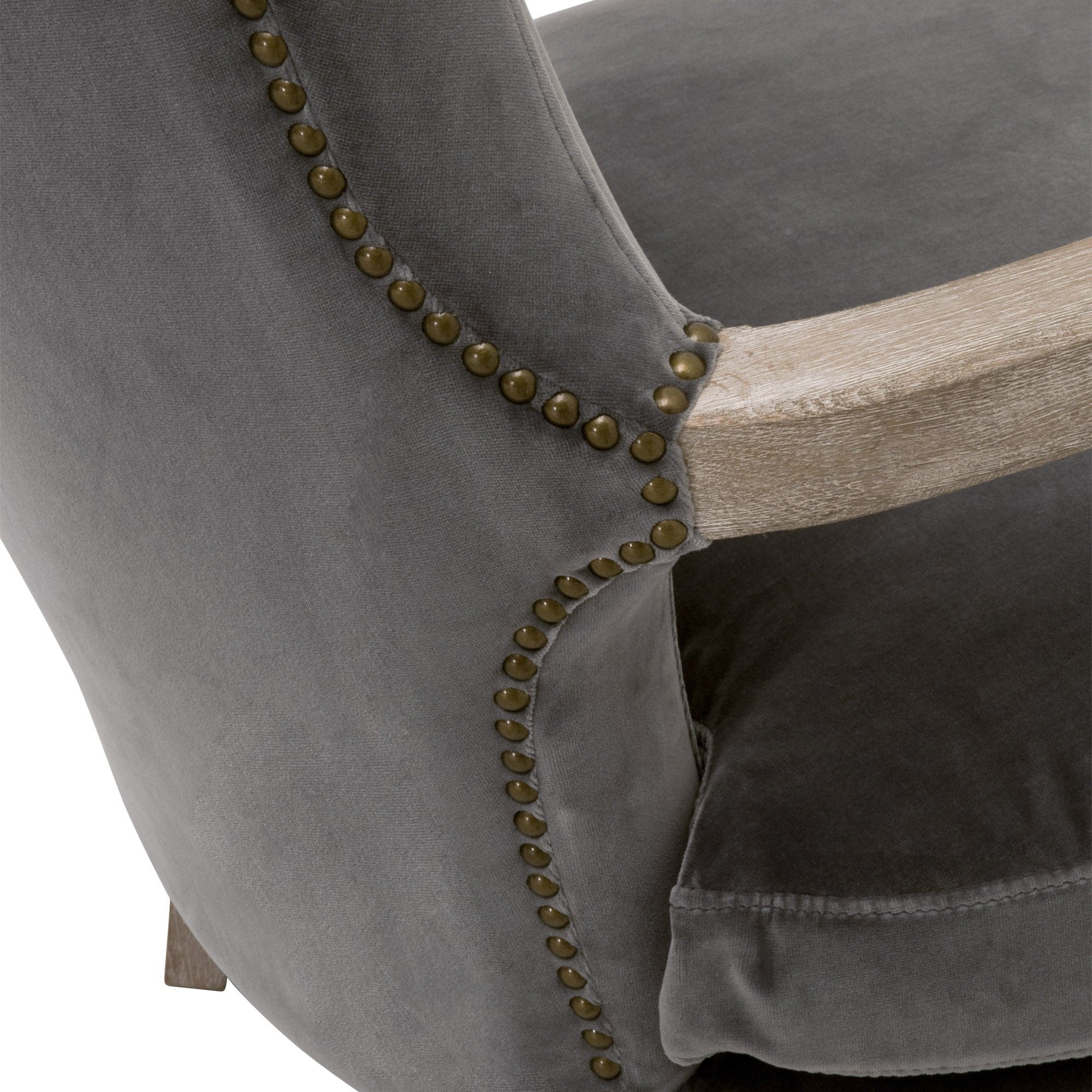 Close-up of dark gray velvet Calvin Club Chair with gold nailhead trim and natural oak wood arm by Essentials for Living