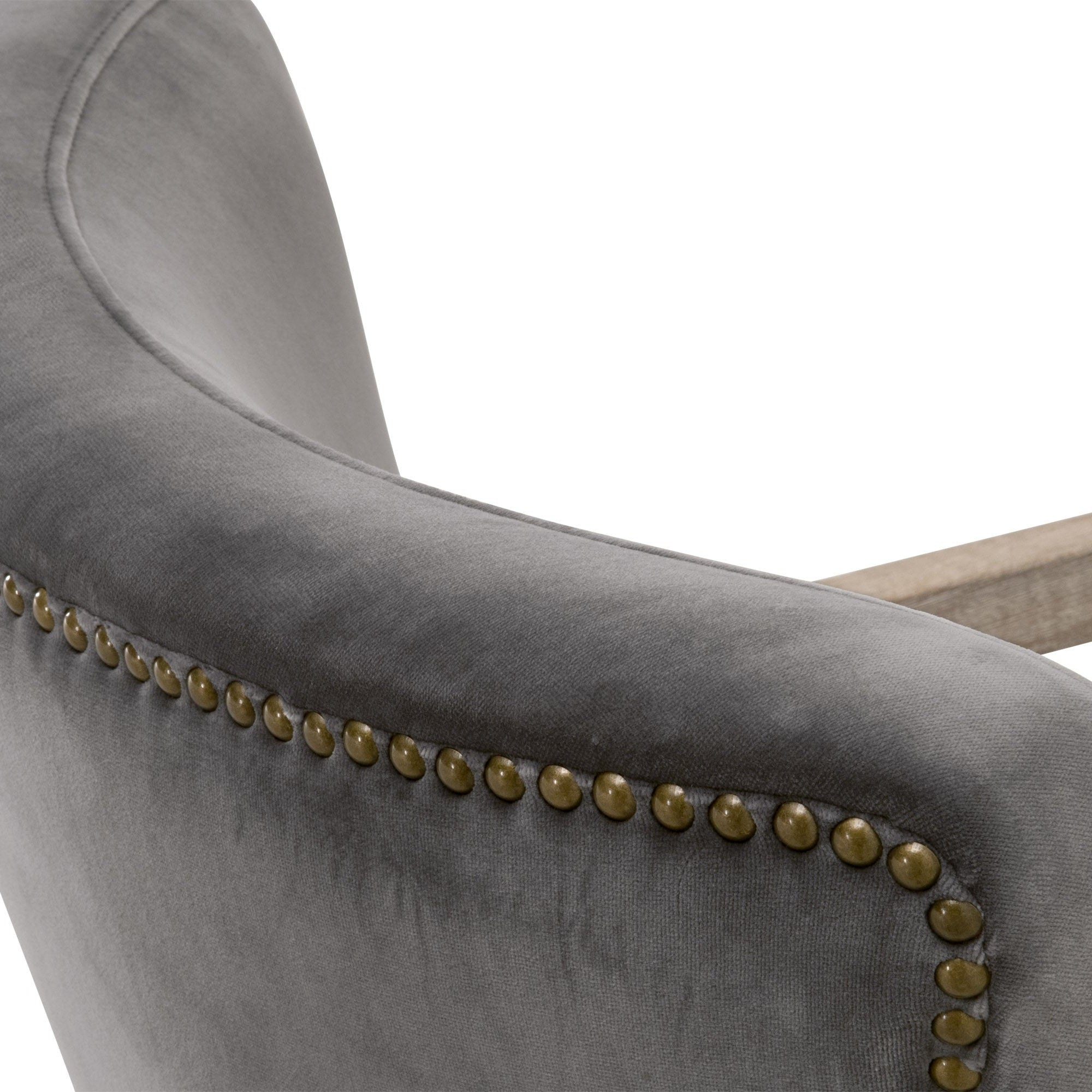 Close-up of Calvin Club Chair in dark gray velvet with gold nailhead trim and oak wood arms by Essentials for Living.