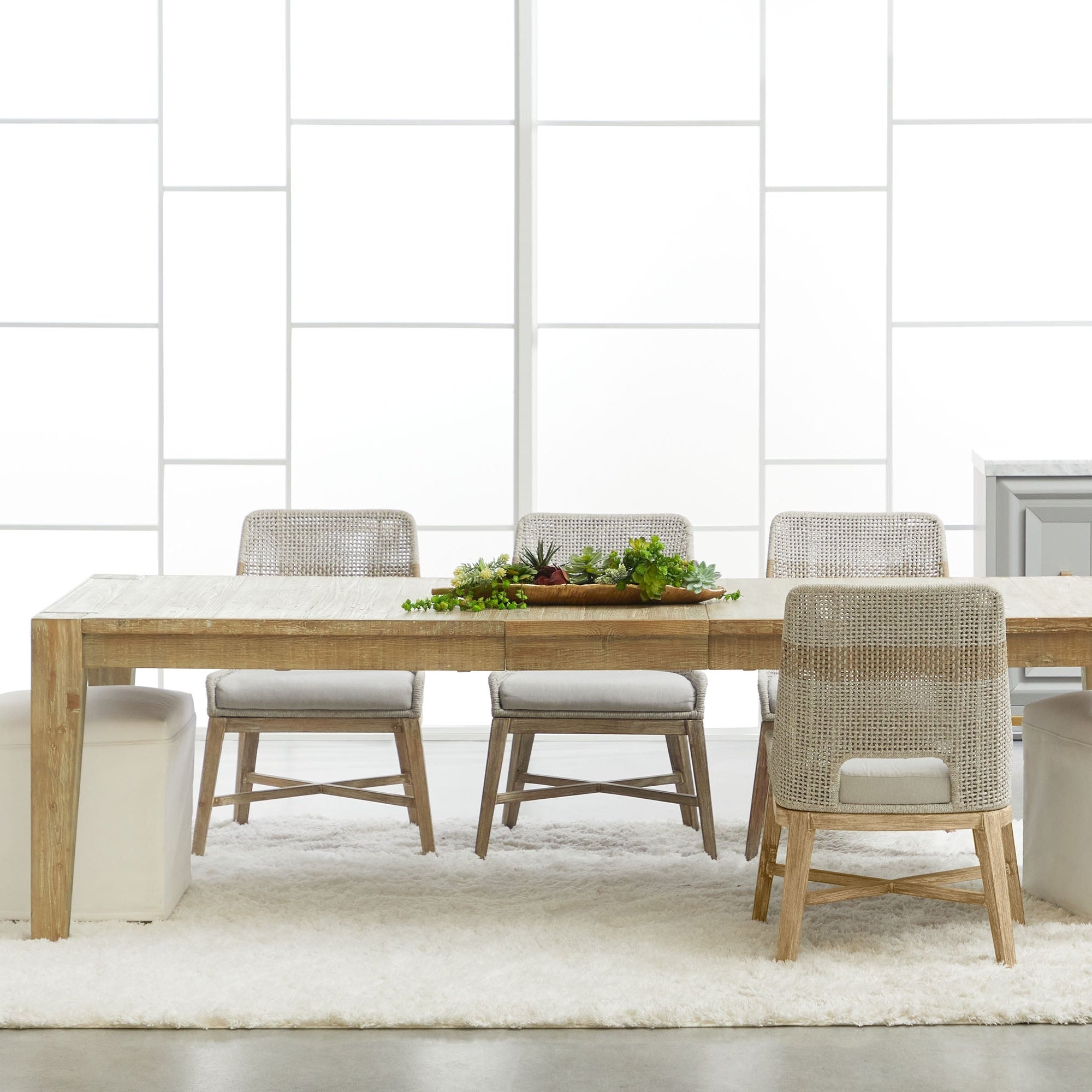 Canal Extension Dining Table by Essentials for Living in smoke gray reclaimed pine with neutral cushioned chairs and plants centerpiece