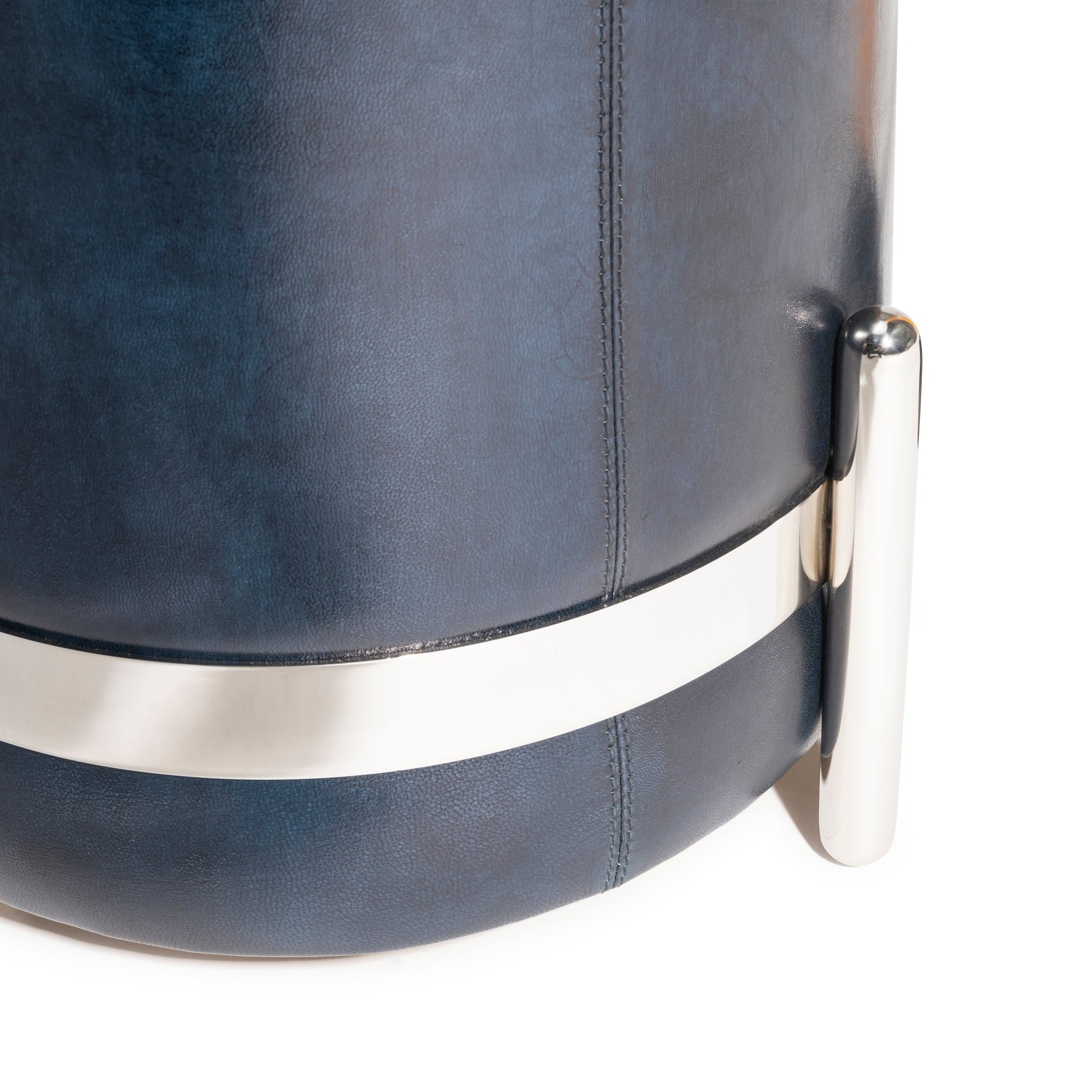 Close-up of navy blue leather and polished nickel base on the Cayman Stool by GO HOME.