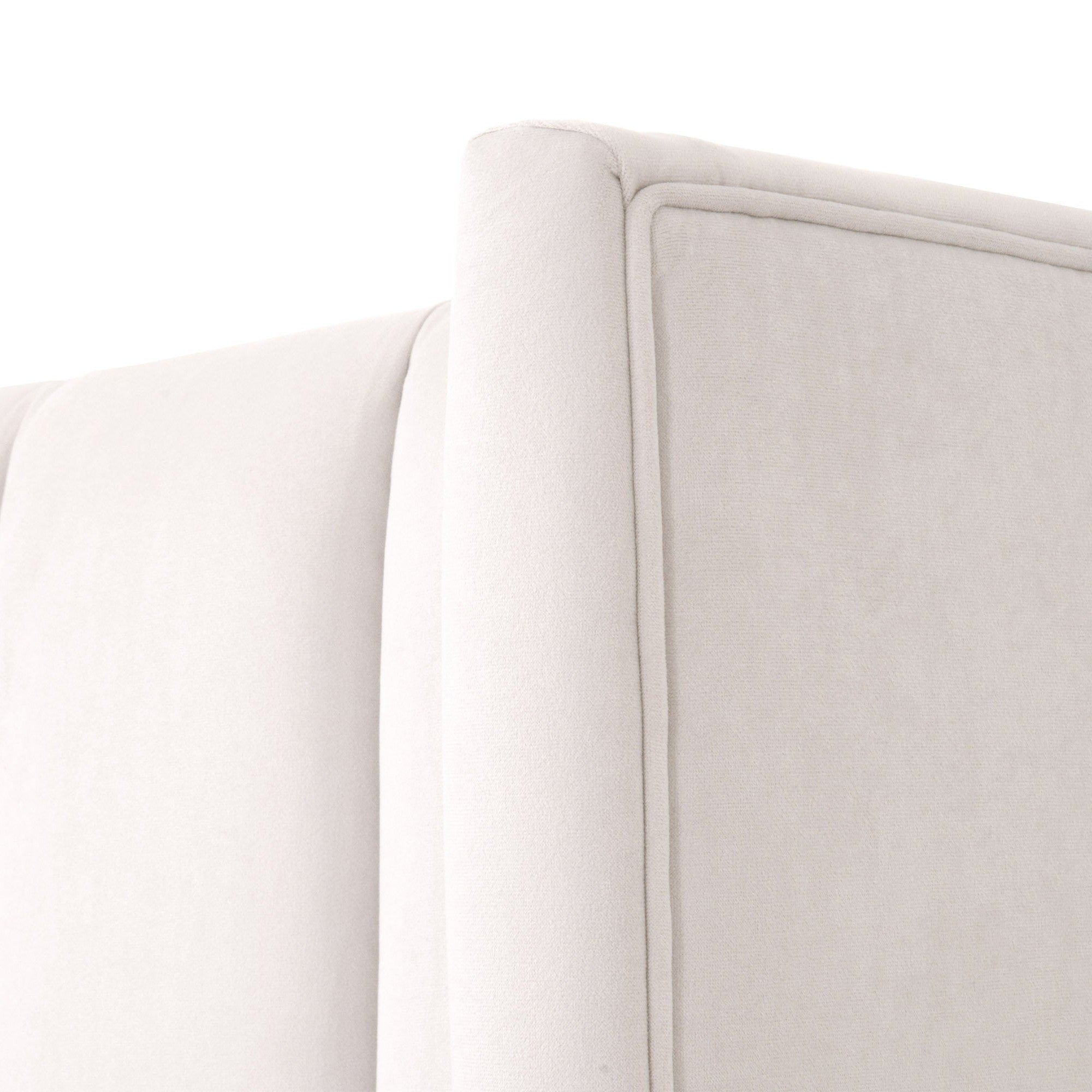 Close-up of cream velvet wingback headboard with vertical channel stitching and piped edge on the Chandler Standard King Bed