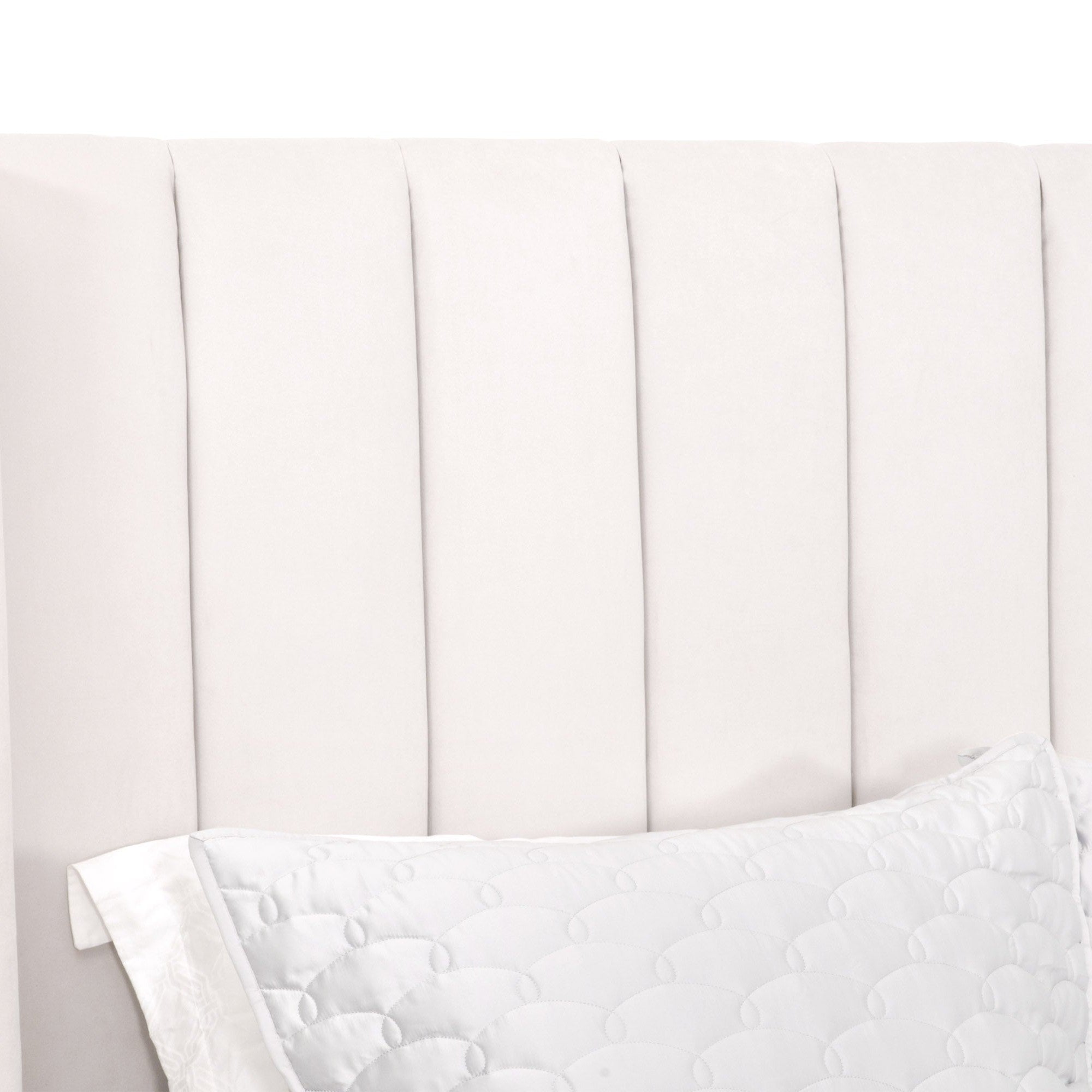 Close-up of cream velvet wingback headboard with vertical channel stitching on Chandler Standard King Bed by Essentials For Living