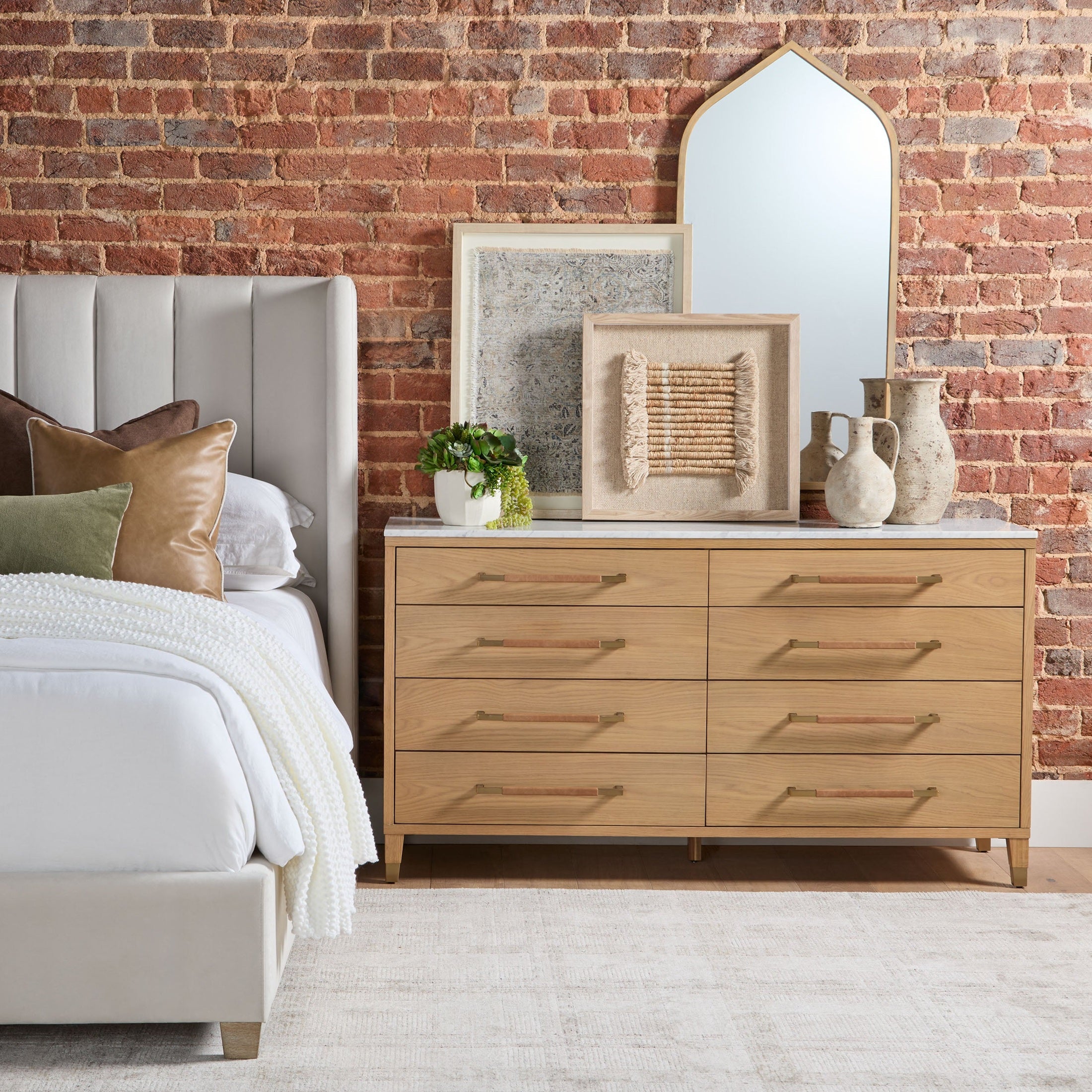 Essentials for Living Chandler Standard King Bed with cream velvet upholstery and exposed natural gray oak feet in a stylish bedroom setting