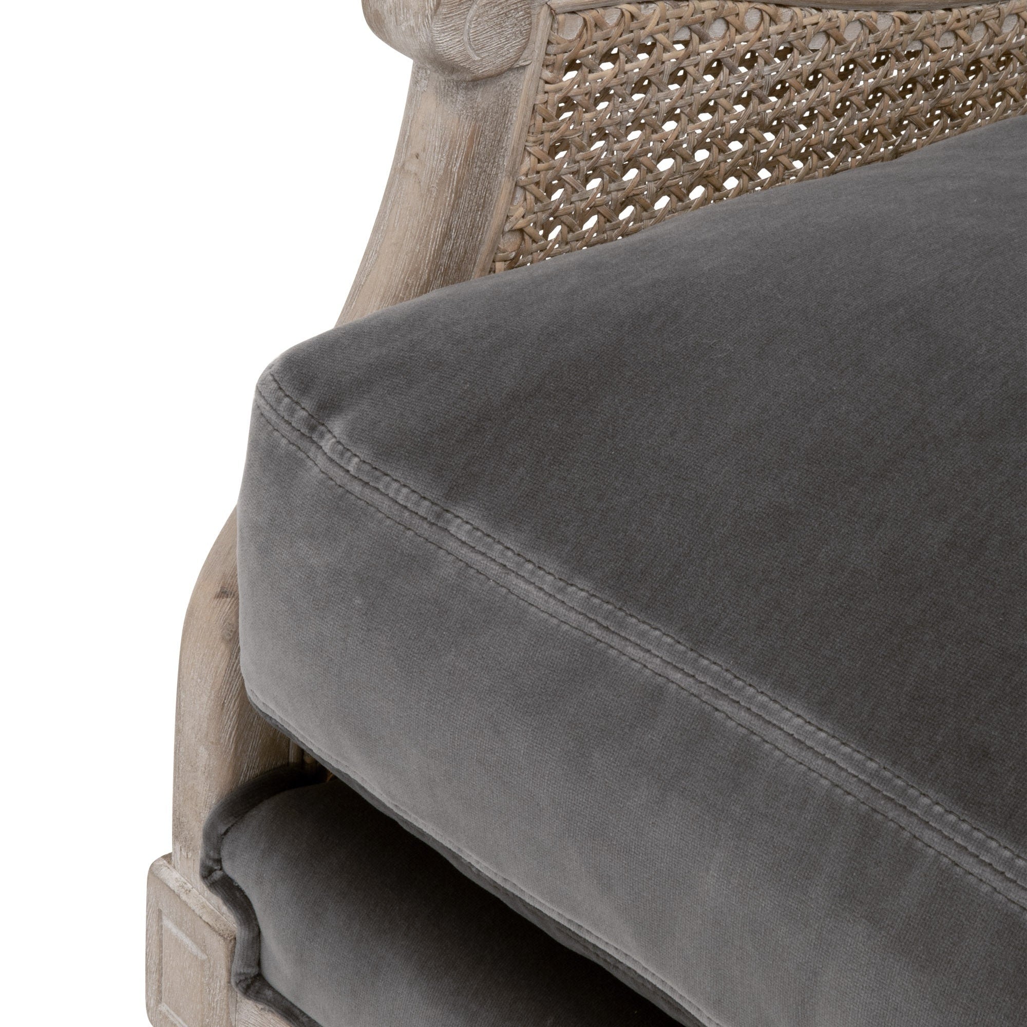 Close-up of Churchill Club Chair showing natural gray oak frame with rattan cane sides and a plush gray cushion