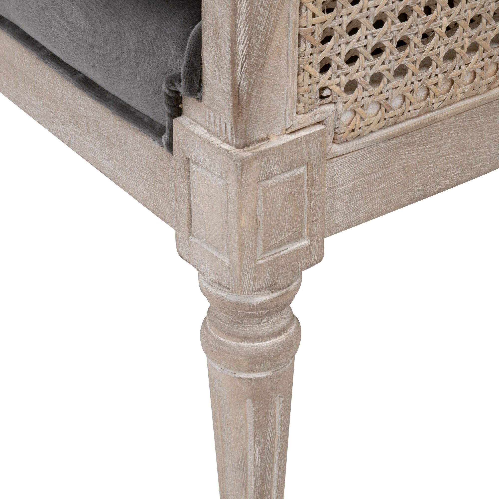 Close-up of a natural gray oak leg and rattan cane side panel on Churchill Club Chair by Essentials For Living