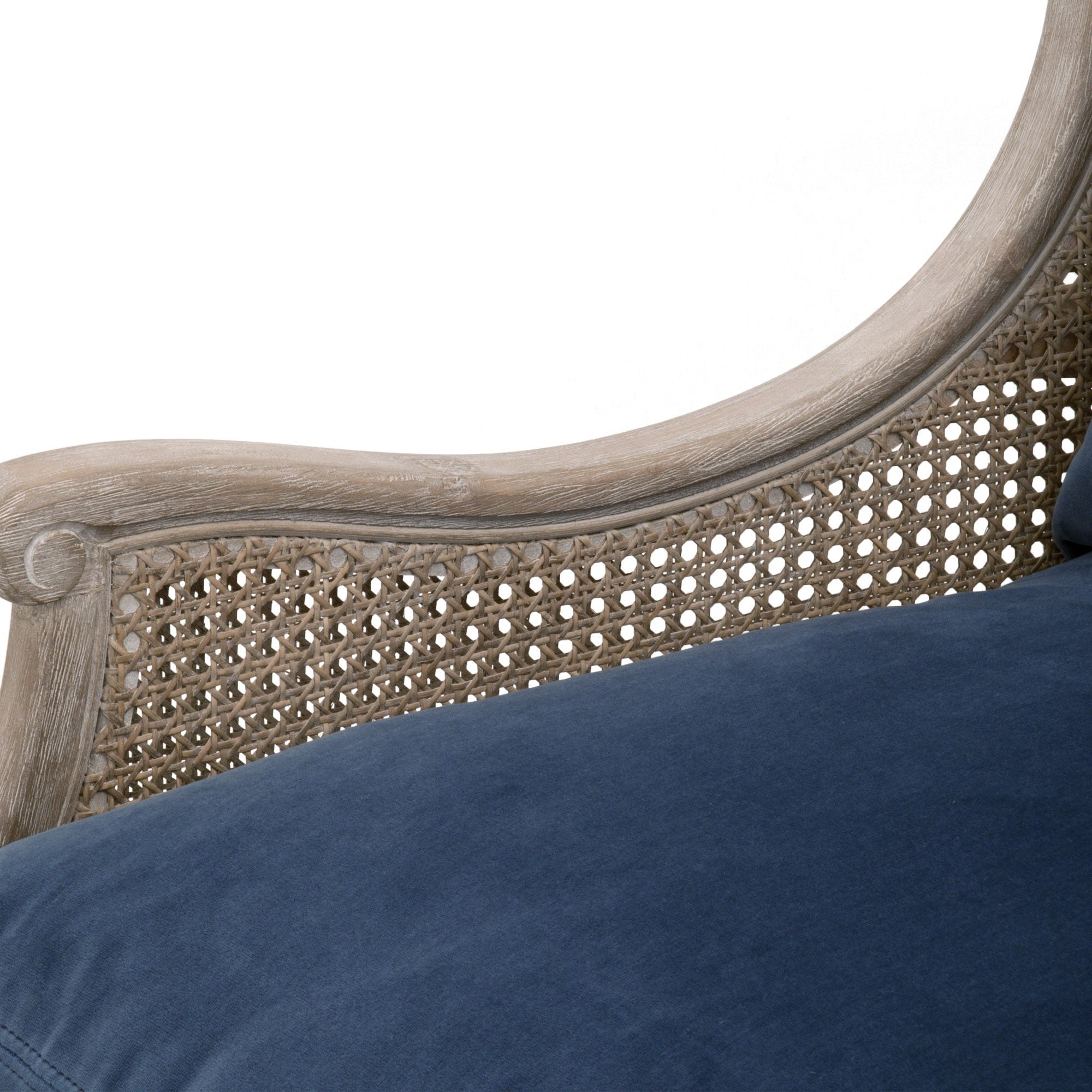 Close-up of Churchill Club Chair showing natural gray oak frame with rattan cane sides and navy blue cushion by Essentials For Living