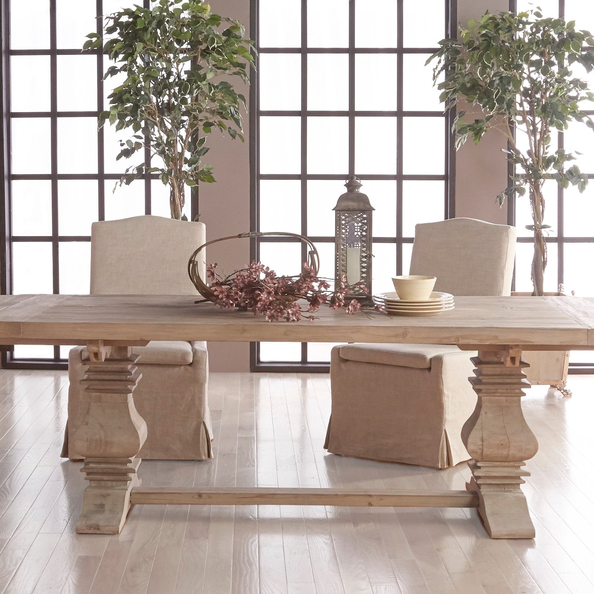 Two creamy bisque Colette slipcover dining chairs by Essentials for Living at a wooden dining table in bright room