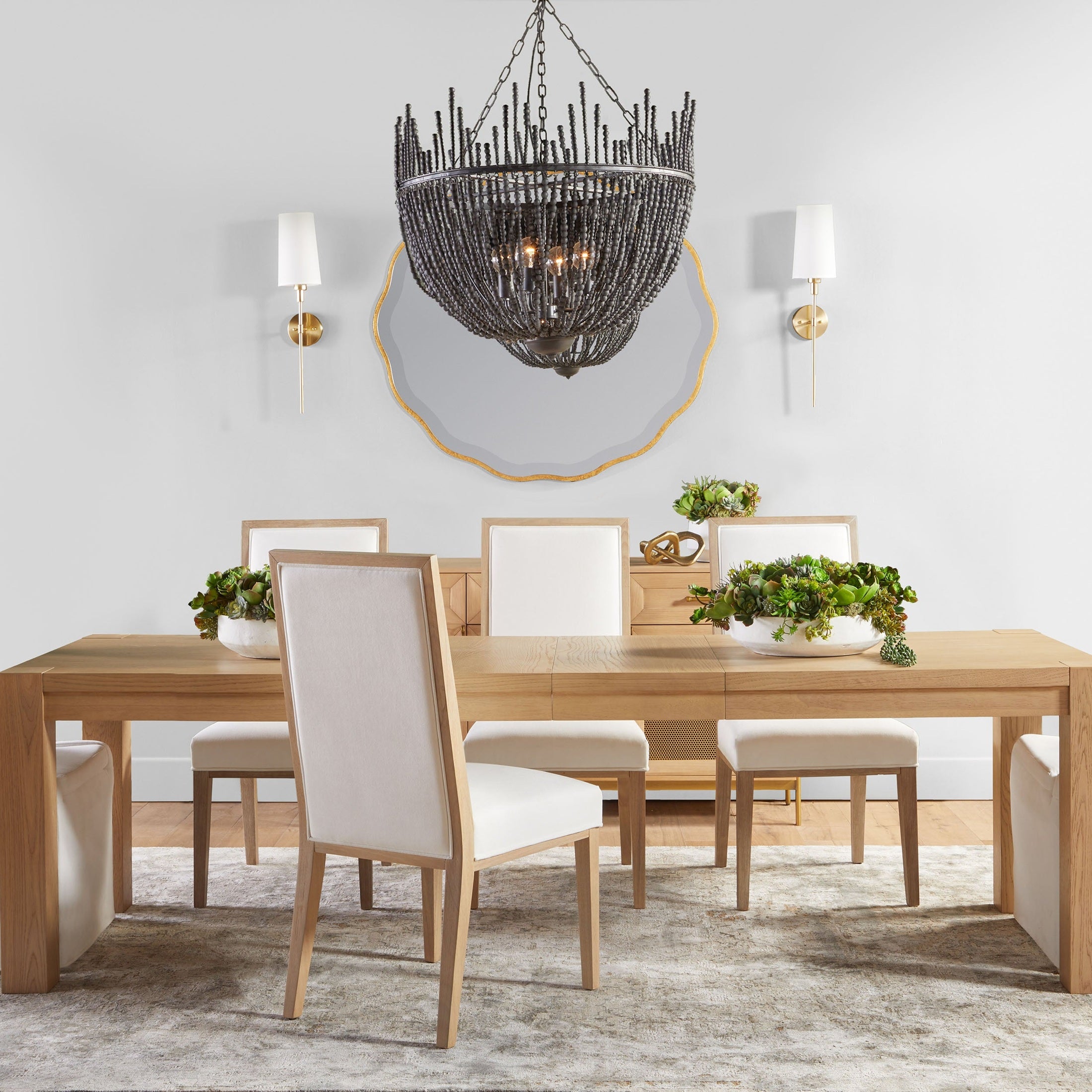 Two Colette slipcover dining chairs with creamy bisque linen and wooden legs in a modern dining room setting