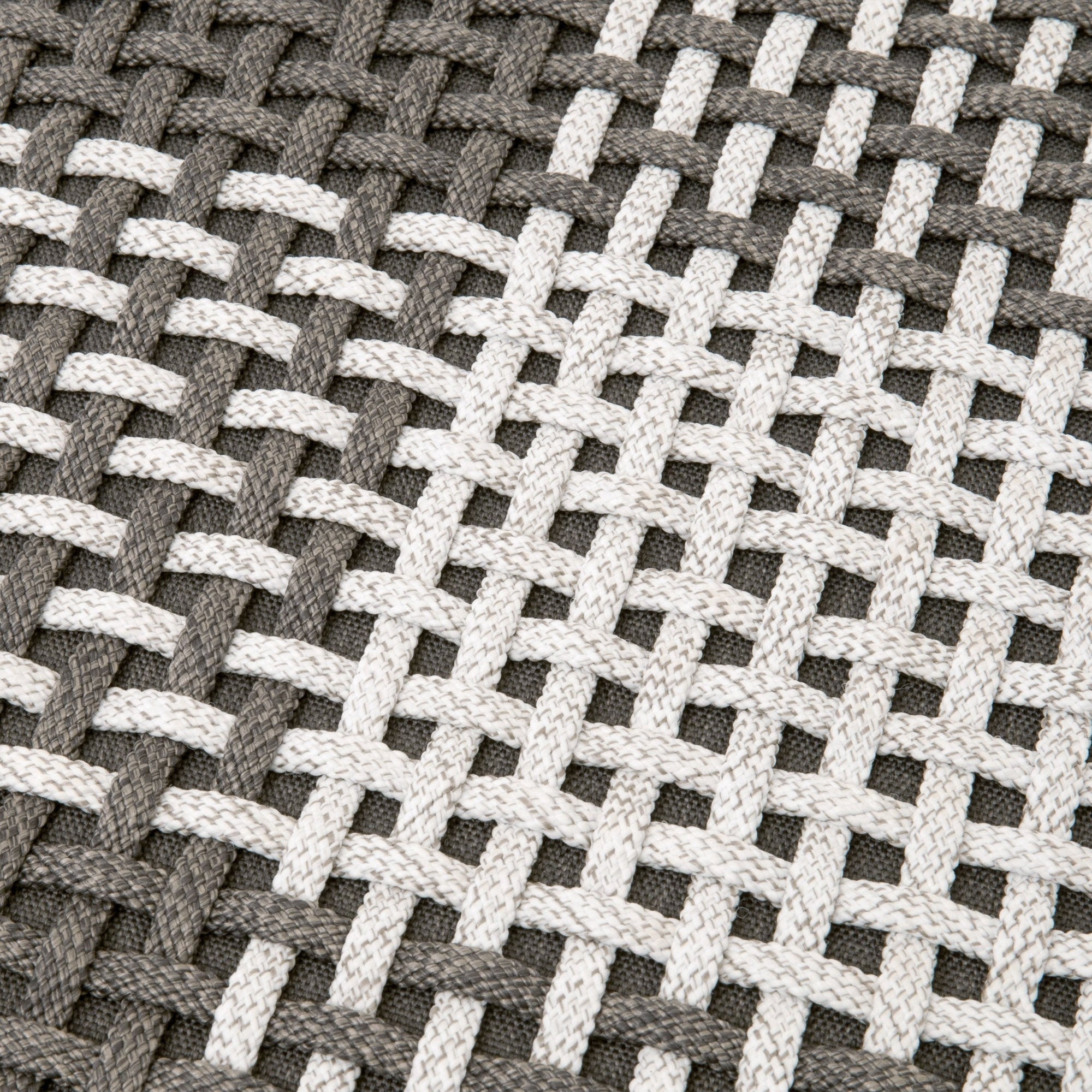 Close-up of taupe and white handwoven rope detailing forming a cross pattern on a woven surface