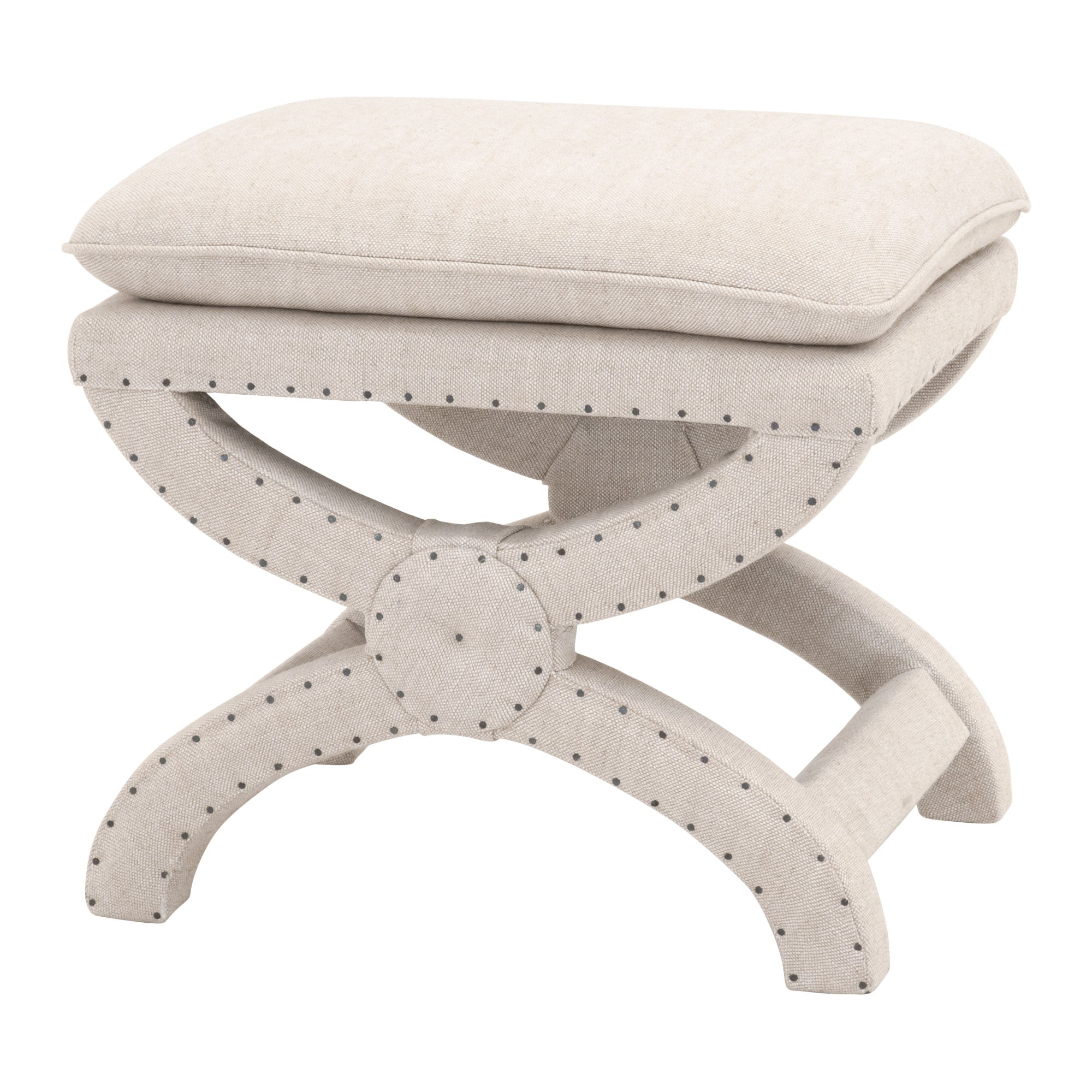 Creamy beige upholstered Gaston Ottoman by Essentials For Living with X-shaped base and black nailhead trim design