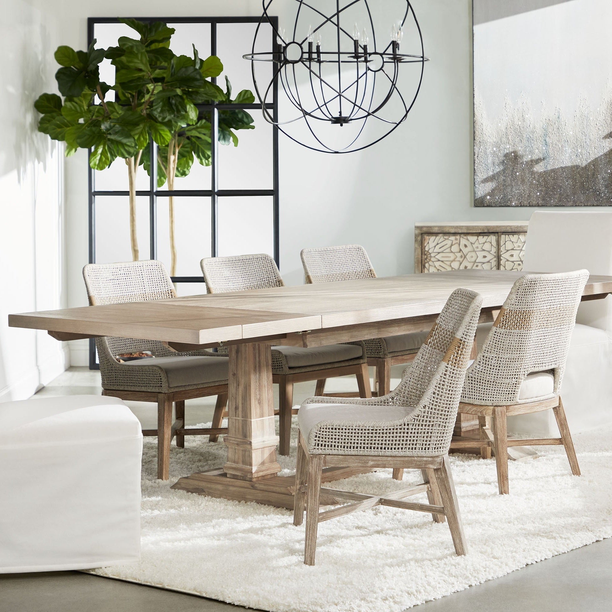 Grid Mirror with matte black oak frame leaning in bright dining room by Essentials for Living.