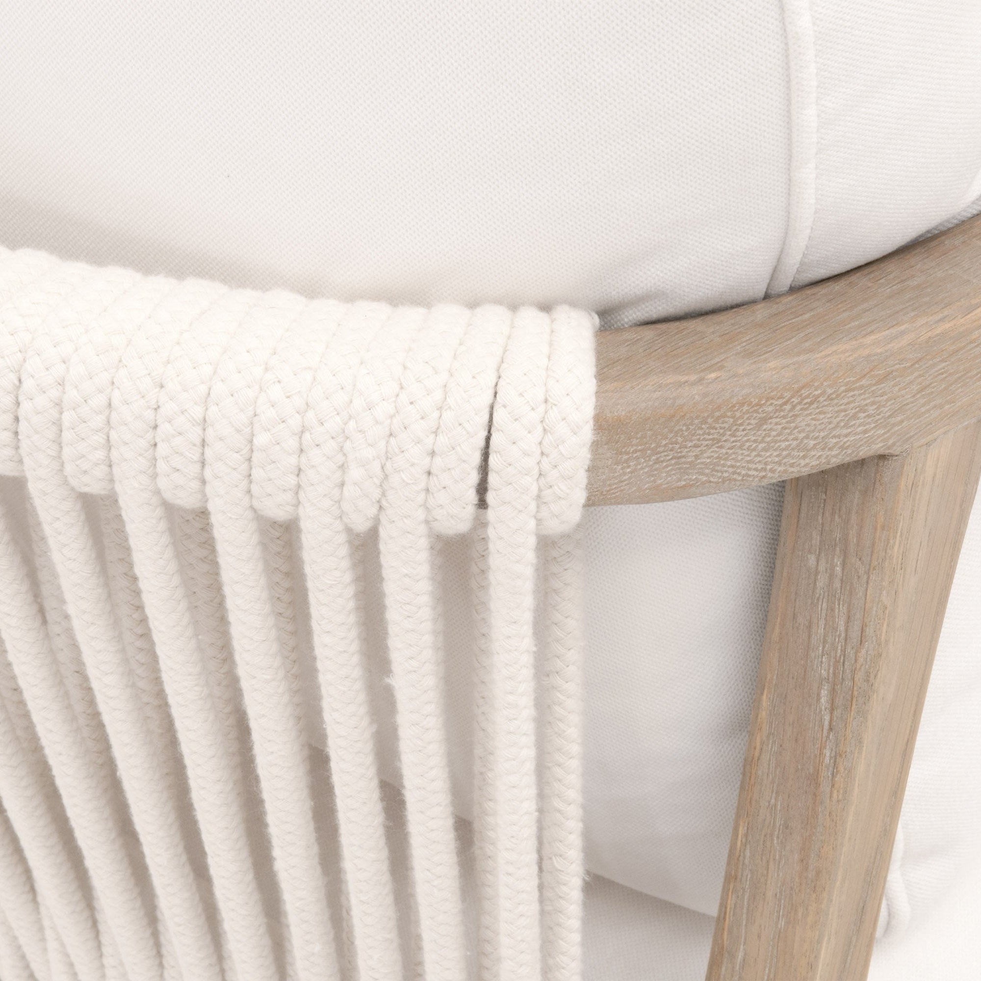 Close-up of Harbor Club Chair’s smoke-gray oak frame with white rope weave and white fabric cushion detail.