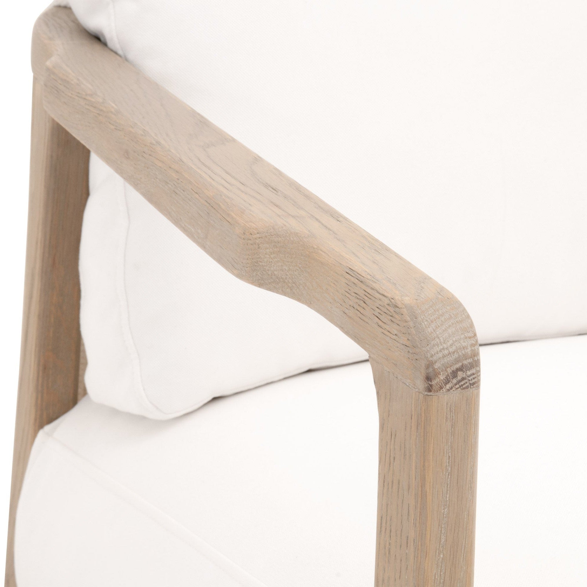Close-up of Harbor Club Chair’s smooth smoke-gray oak armrest and white performance fabric cushions