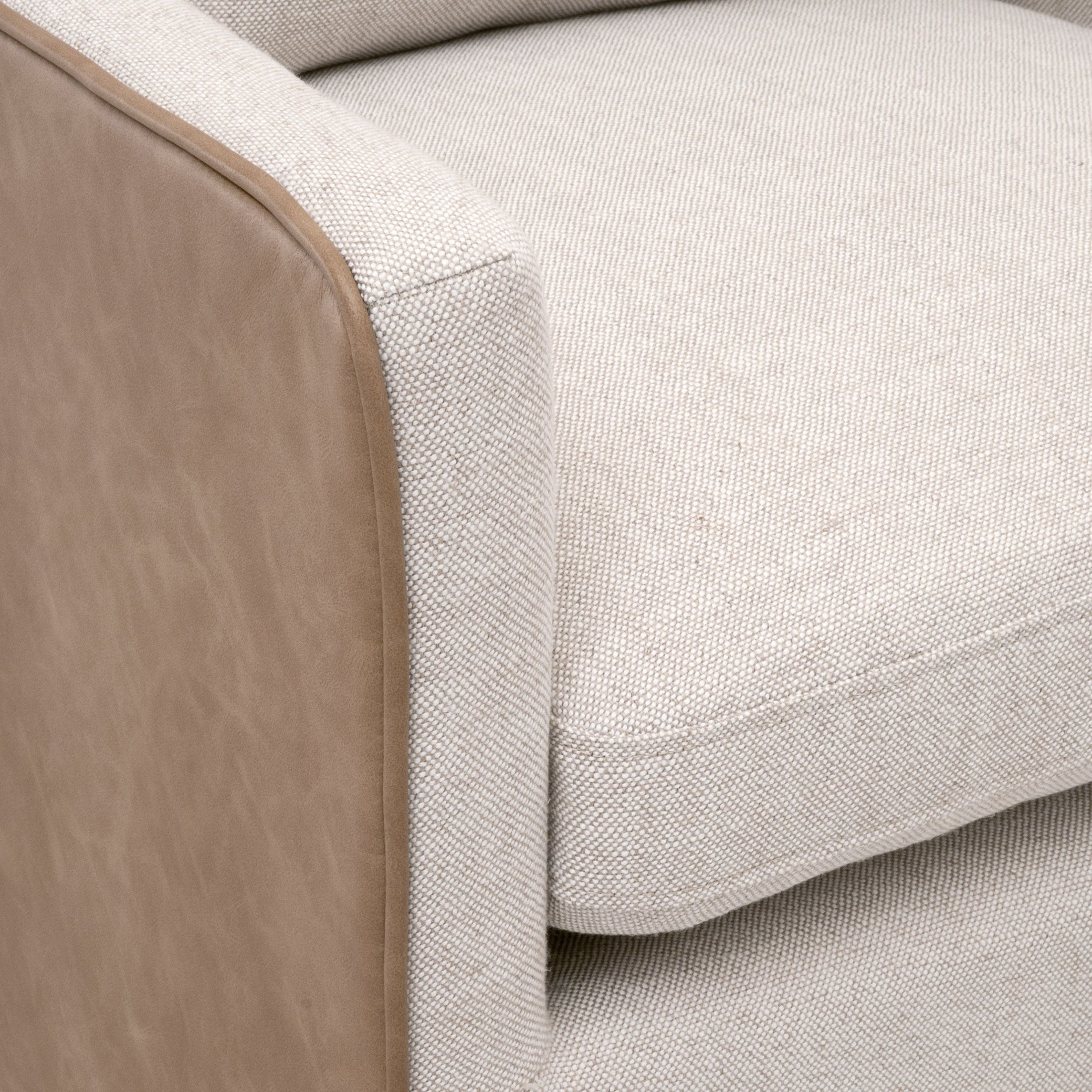 Close-up of Essentials for Living Harmony Arm Chair with two-tone fabric and leather upholstery detailing.