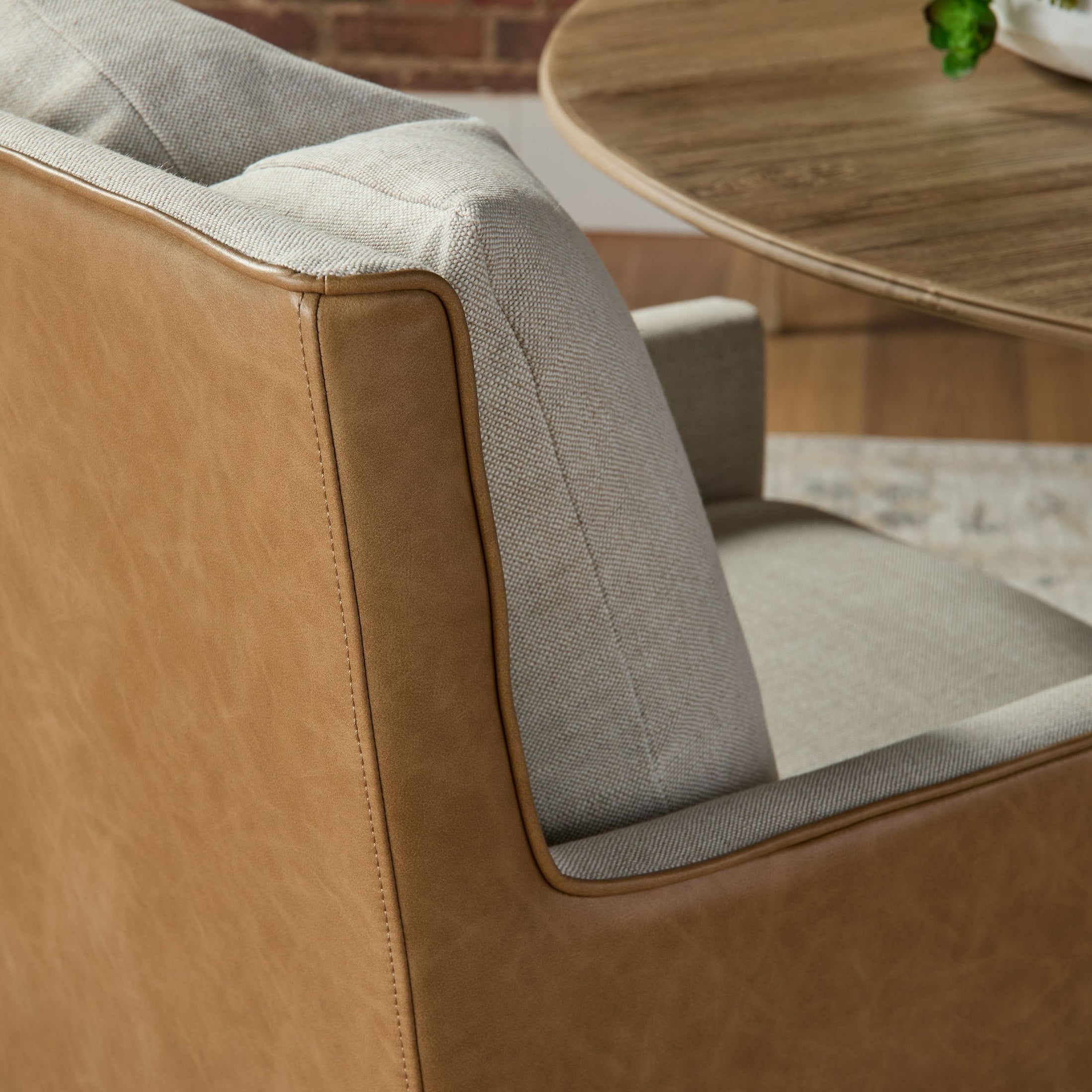 Close-up of the Harmony Arm Chair with two-tone upholstery and contrasting edge piping by Essentials for Living