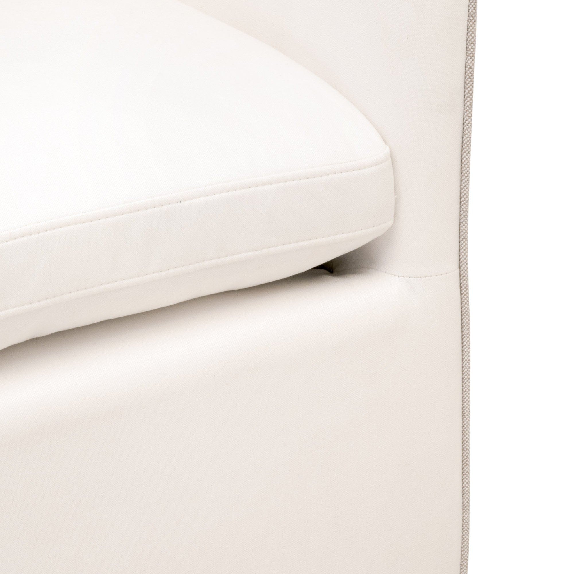 Close-up of the Harmony Arm Chair with Casters showing white fabric upholstery and contrasting edge piping detail.