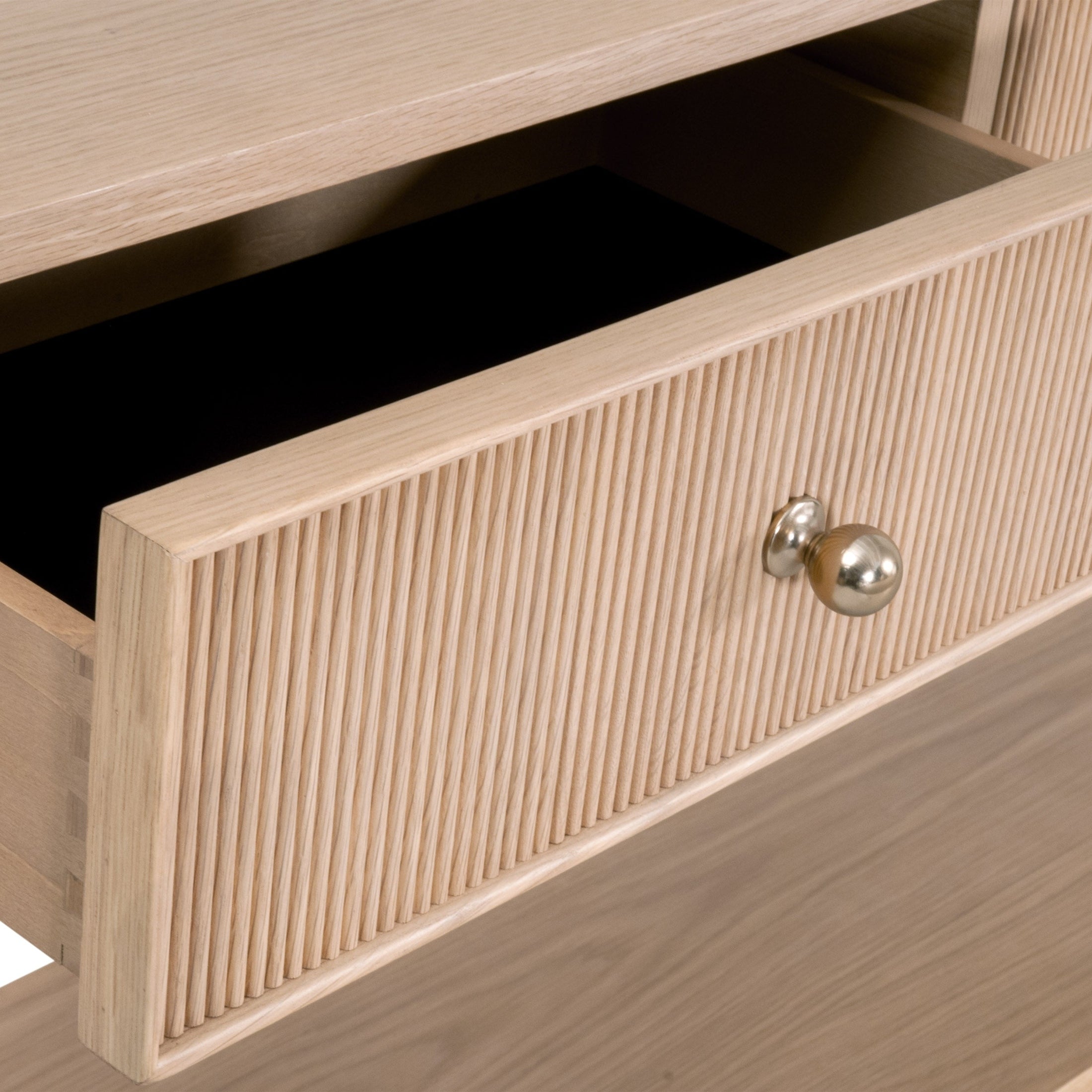 Close-up of fluted front drawer with polished brass knob on Highland 3-Drawer Console Table by Essentials for Living.