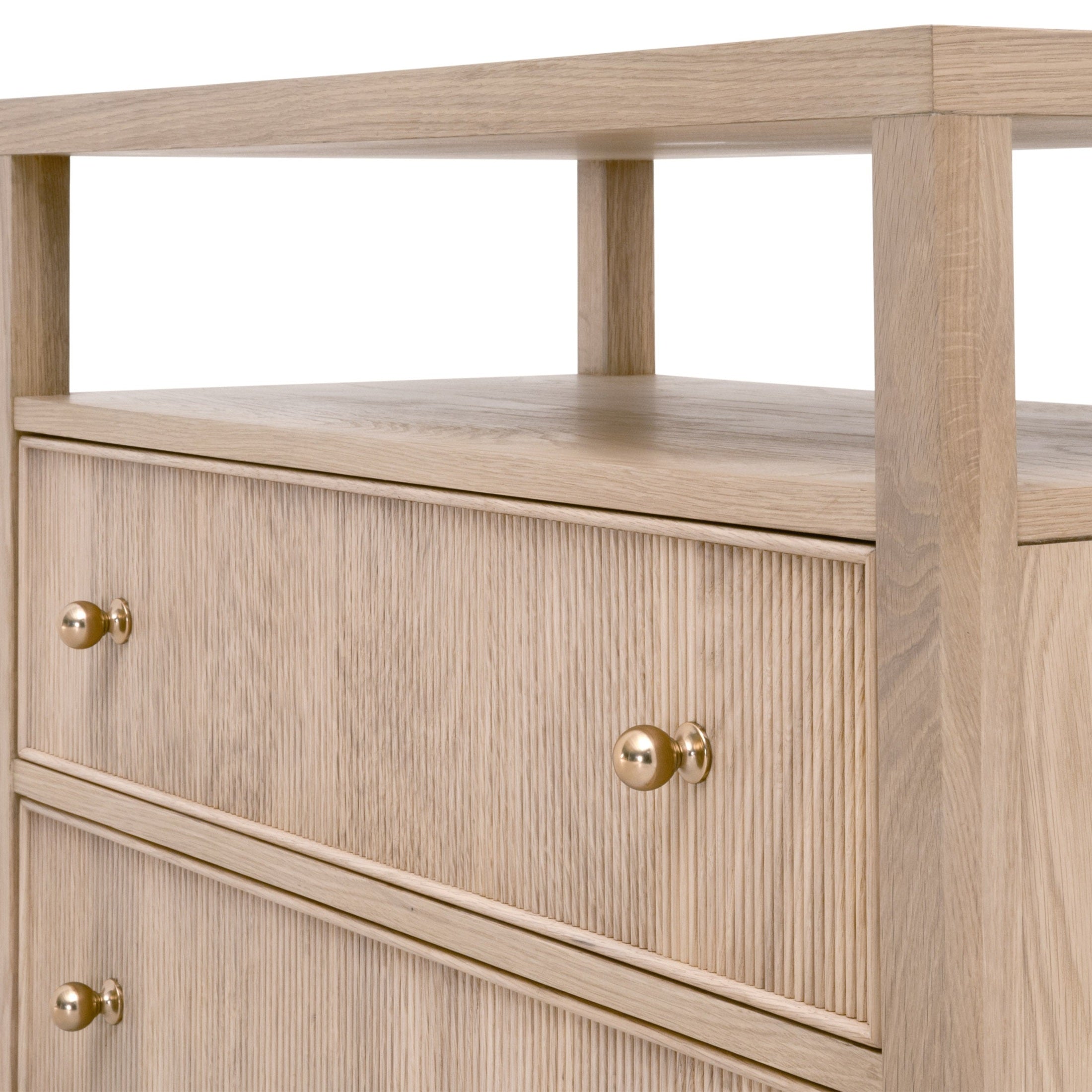 Close-up of the fluted wood drawer fronts and polished brass knobs on a light oak 2-drawer nightstand