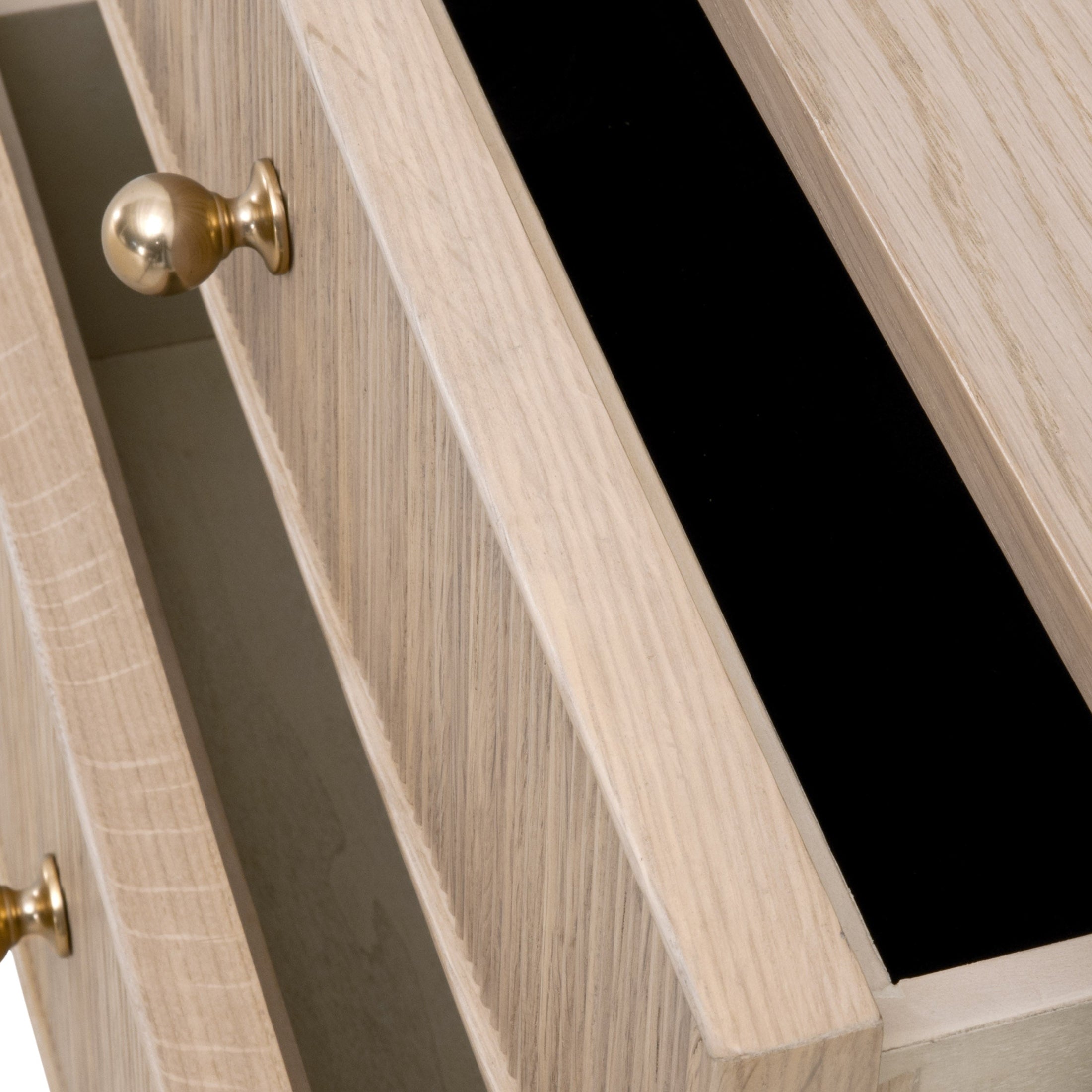 Close-up of the Highland nightstand’s fluted oak drawer with polished brass knob and felt-lined interior by Essentials For Living