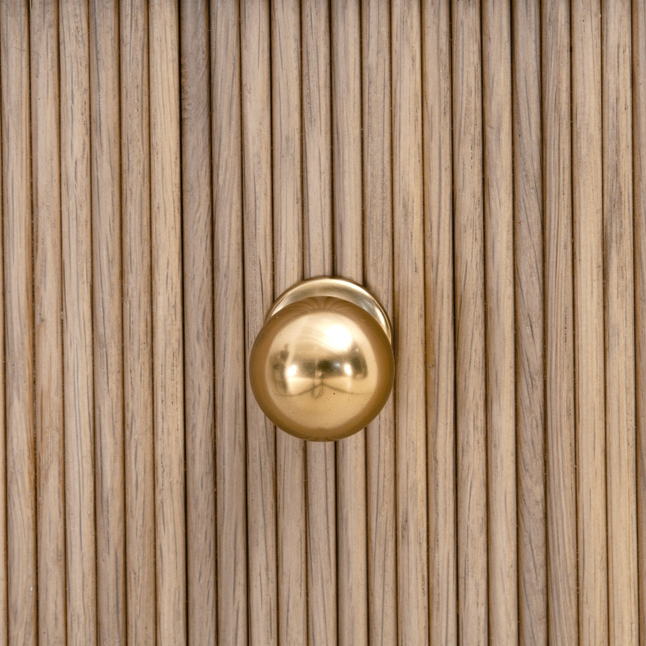 Close-up of natural oak fluted wood drawer front with polished brass iron knob on Highland nightstand