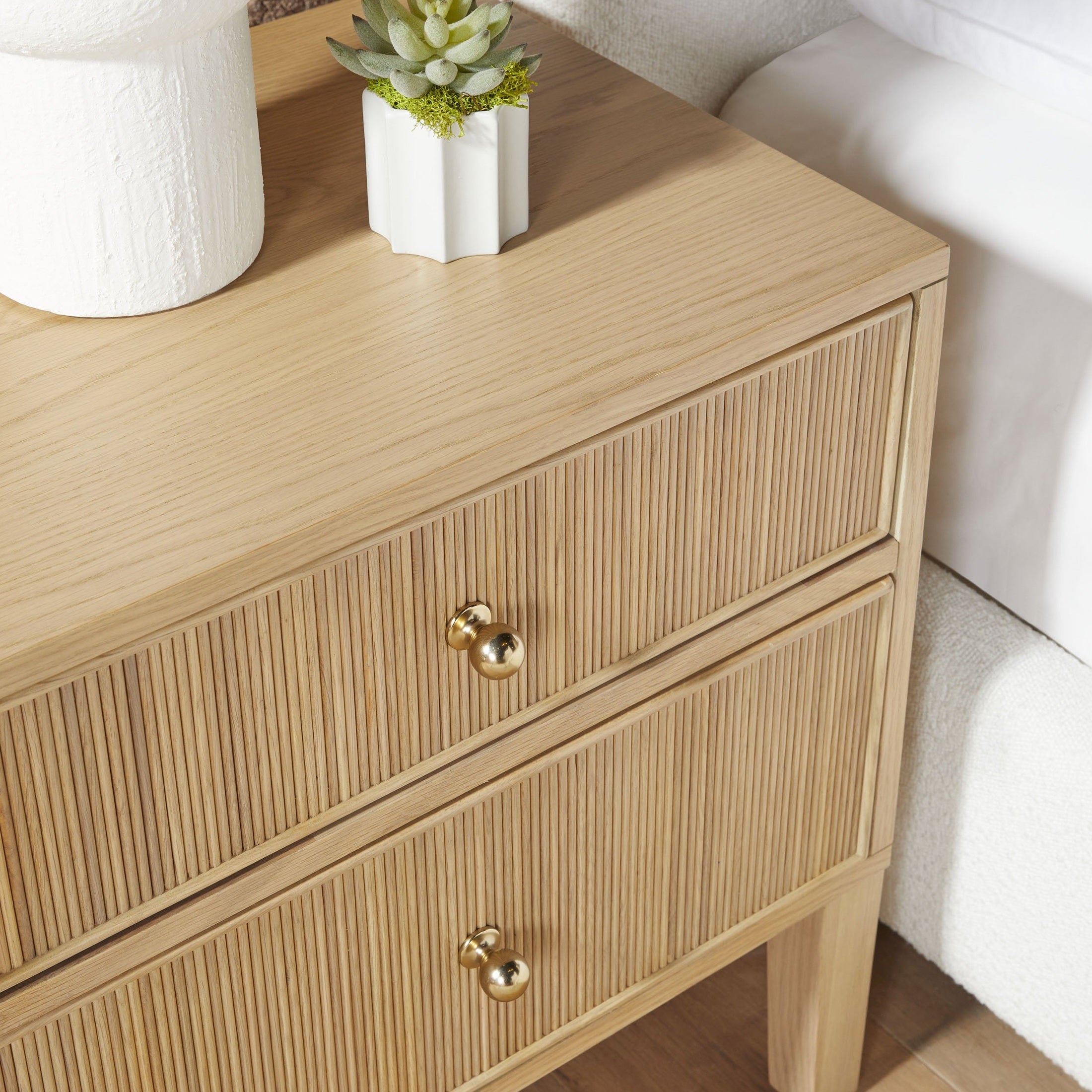 Close-up of Highland 2-drawer nightstand in natural oak with fluted drawer fronts and brass knobs by Essentials for Living