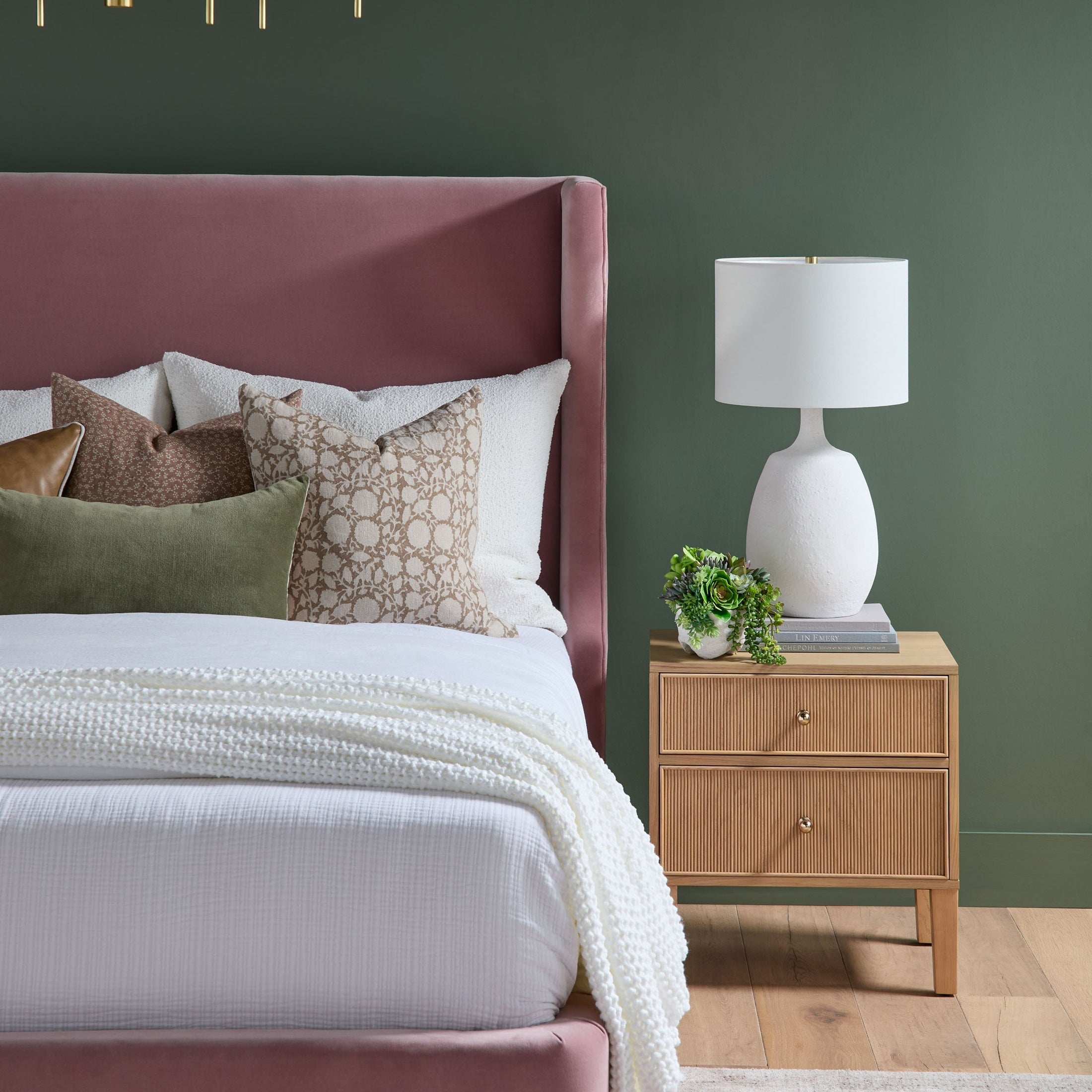 Highland 2-drawer oak nightstand with brass knobs and fluted detailing by Essentials For Living next to a bed and lamp