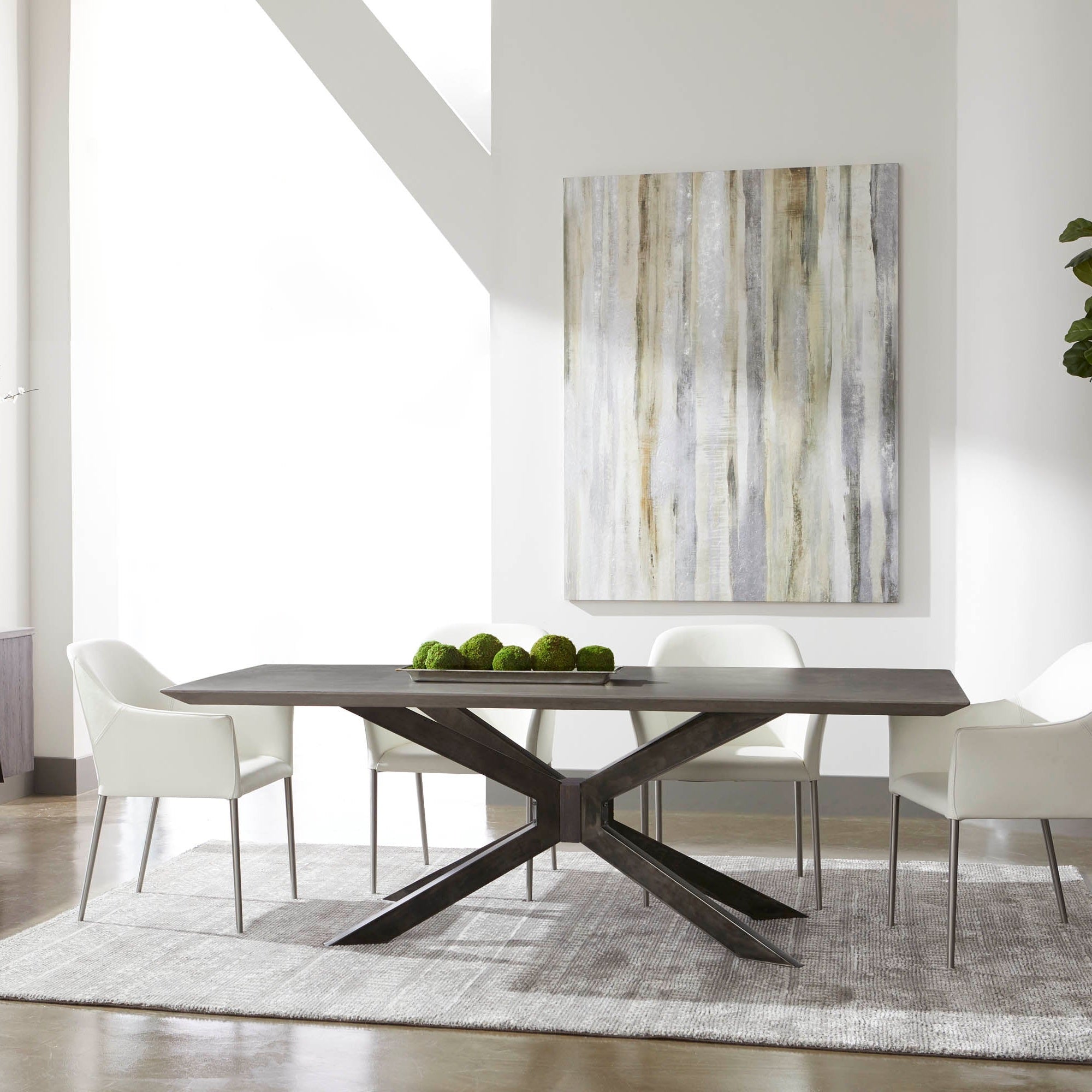 Essentials for Living dining table with industrial black iron base and rectangular dark wood top in modern dining room setting