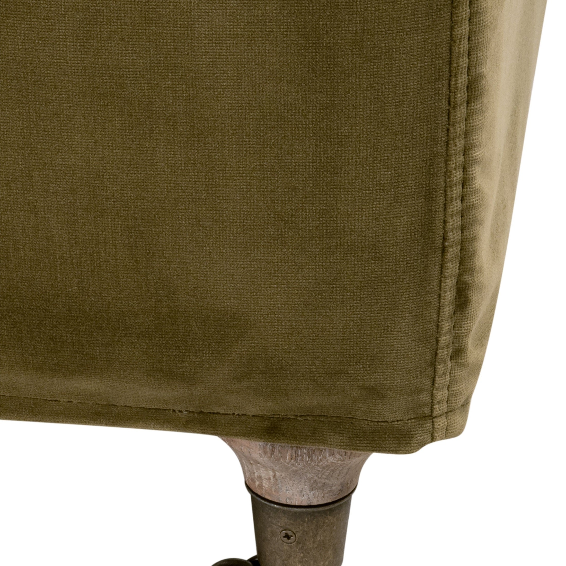 Close-up of olive velvet upholstery and natural gray oak base with brass caster on Jade Slipcover Club Chair by Essentials for Living