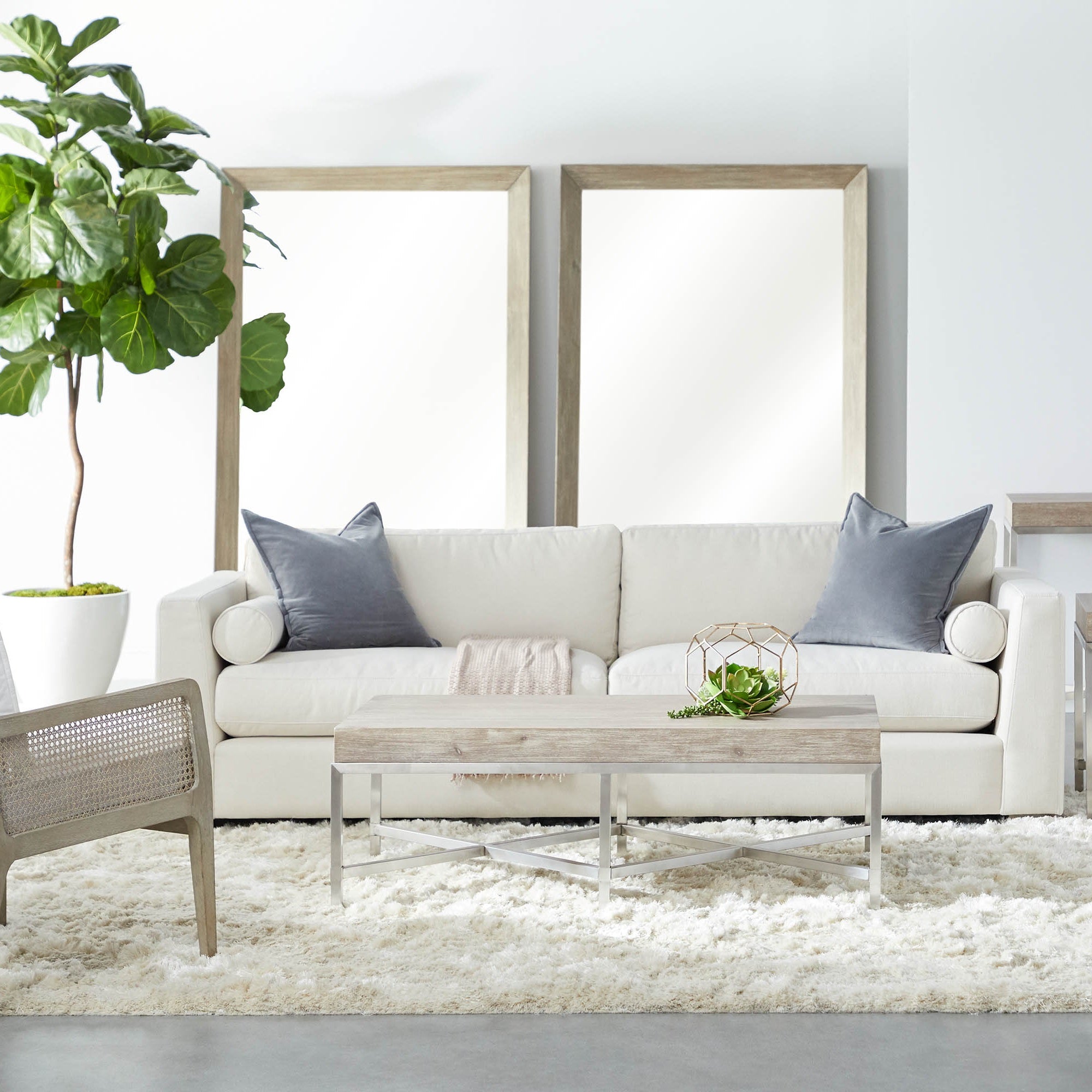 Modern living room with neutral sofa, light wood coffee table, plush rug, and Leone Club Chair by Essentials For Living