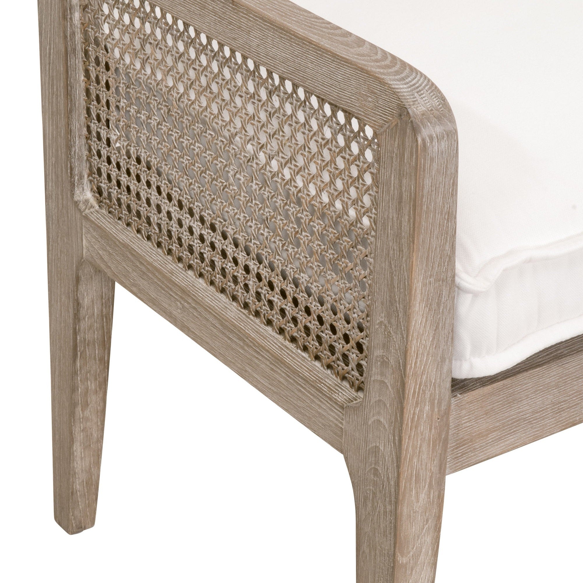 Close-up of Leone Club Chair corner showing natural gray oak frame and classic cane inlay with white cushion by Essentials for Living