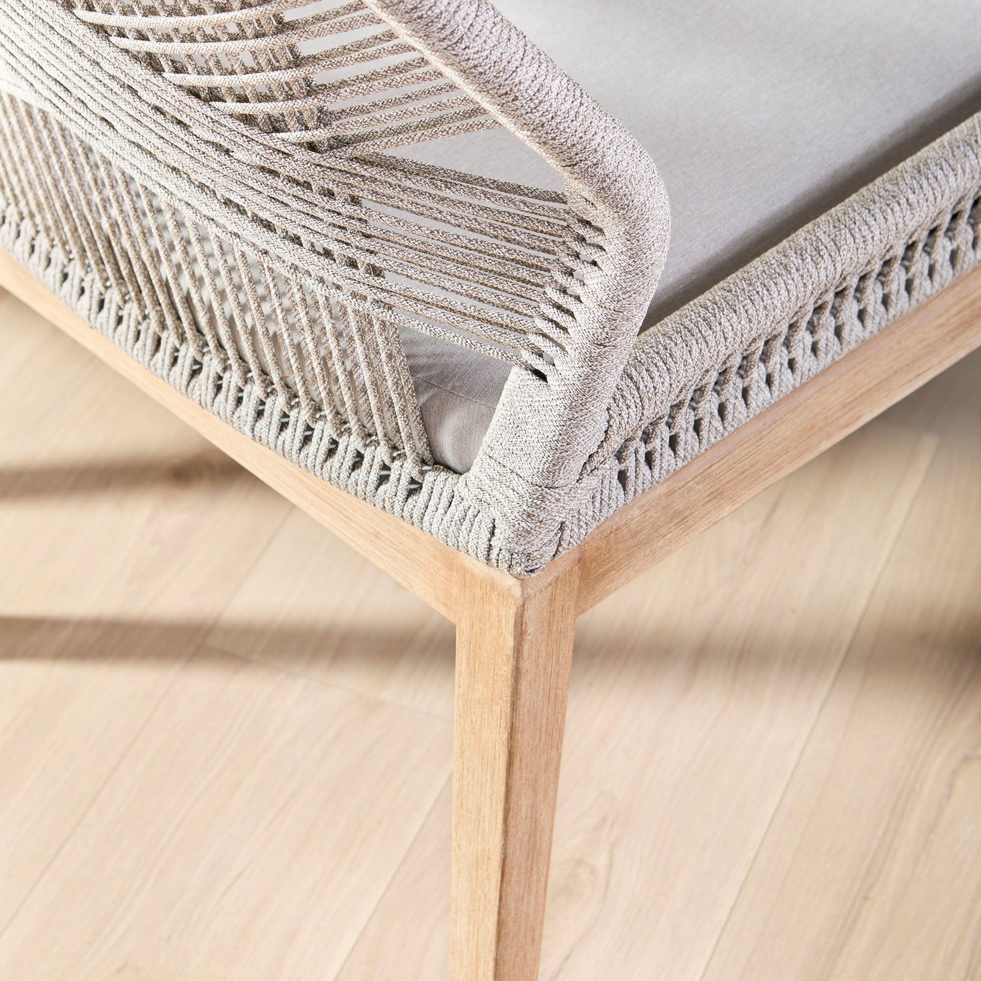 Close-up of a Loom Dining Chair corner showing handwoven taupe rope and natural gray wood frame by Essentials For Living