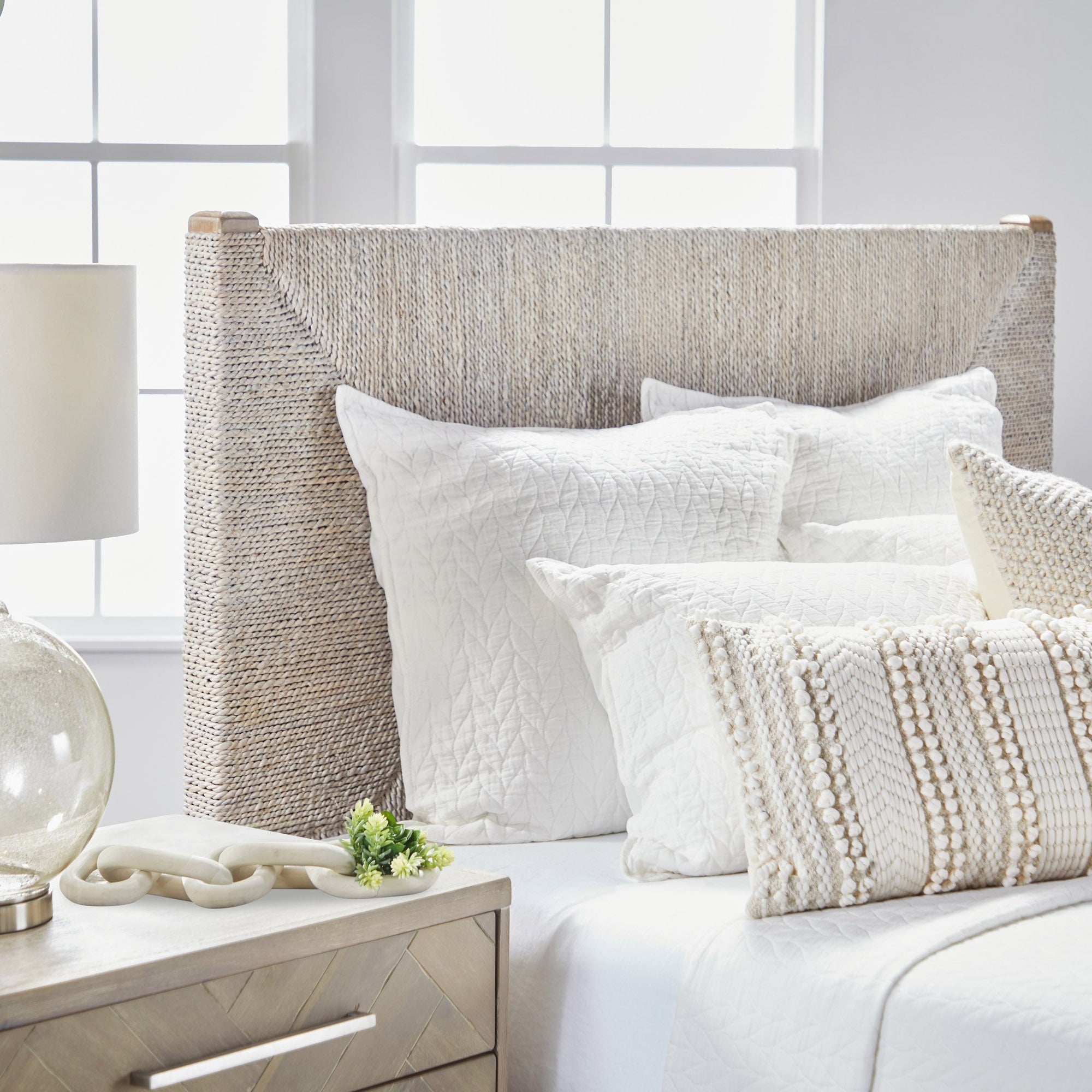 Malay Queen Bed with white-washed abaca rope headboard and neutral bedding by Essentials For Living