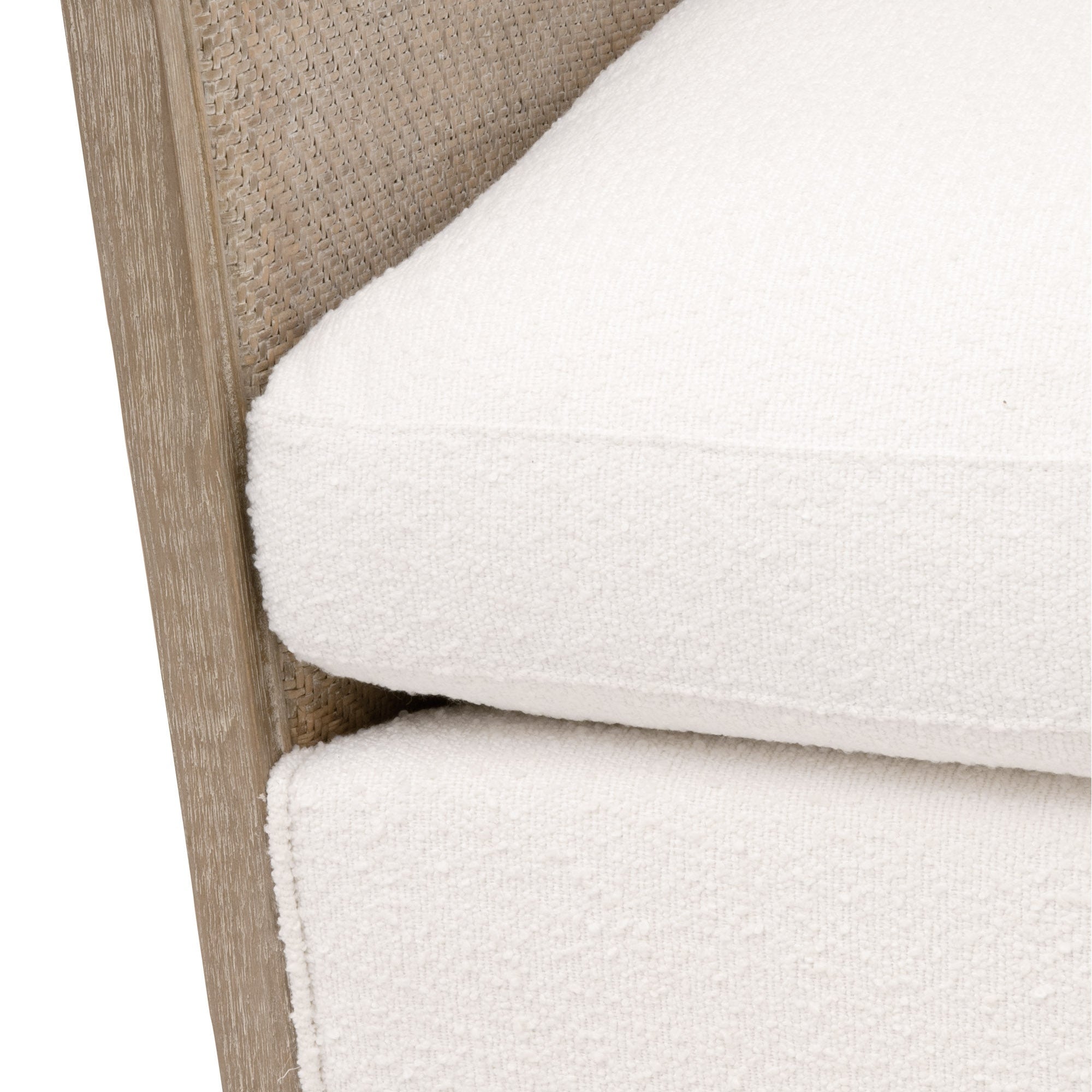 Close-up of Essentials For Living McGuire Swivel Club Chair showing natural cane frame and Snow Boucle upholstery cushions