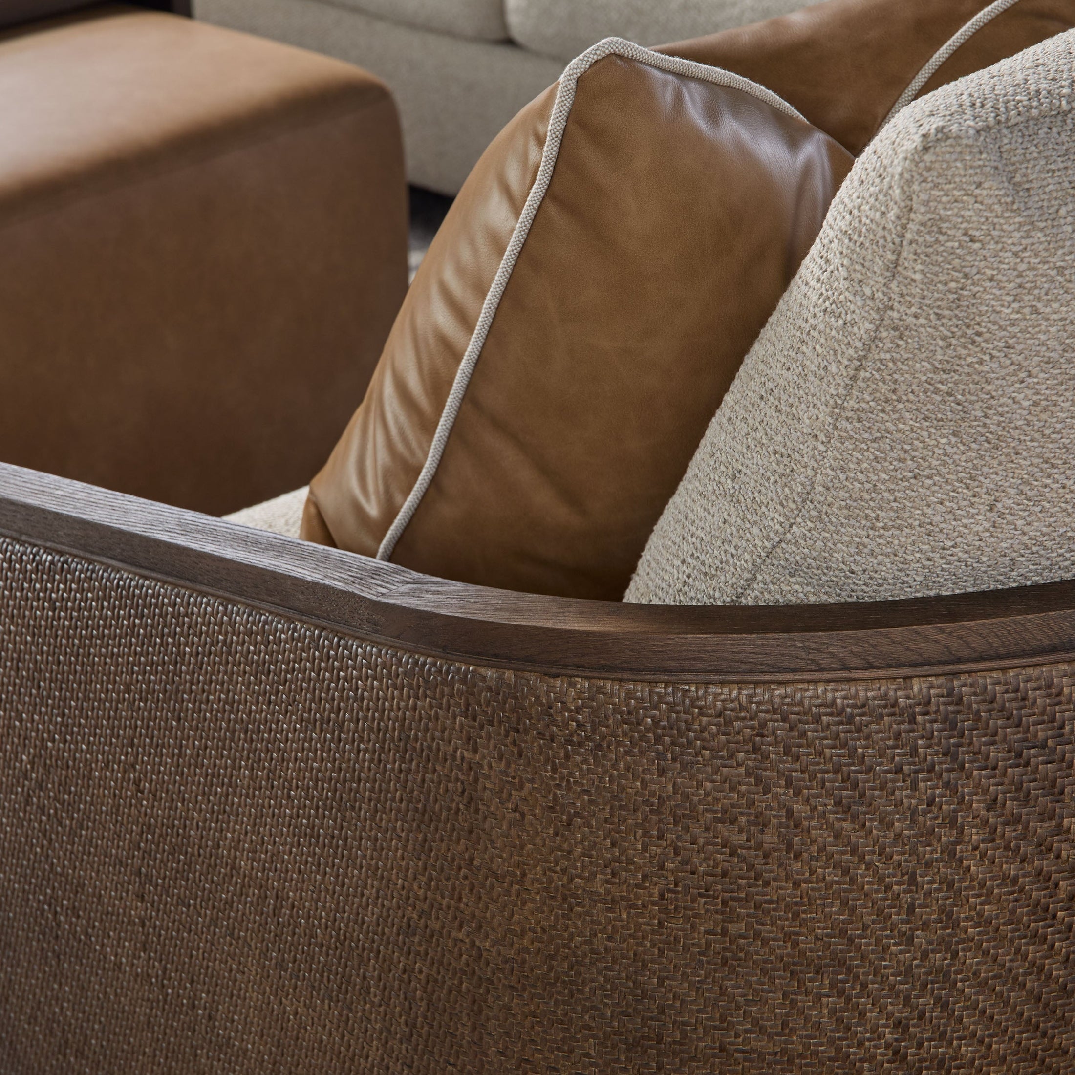 Close-up of McGuire Swivel Club Chair’s handwoven natural cane back and solid oak frame with leather pillow