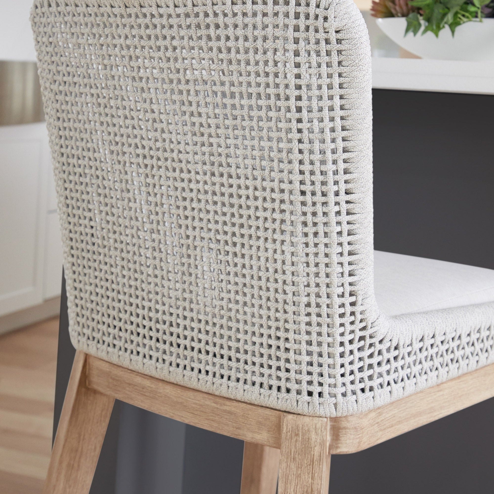 Close-up of white speckle mesh woven back and natural gray mahogany frame on Mesh Counter Stool by Essentials for Living